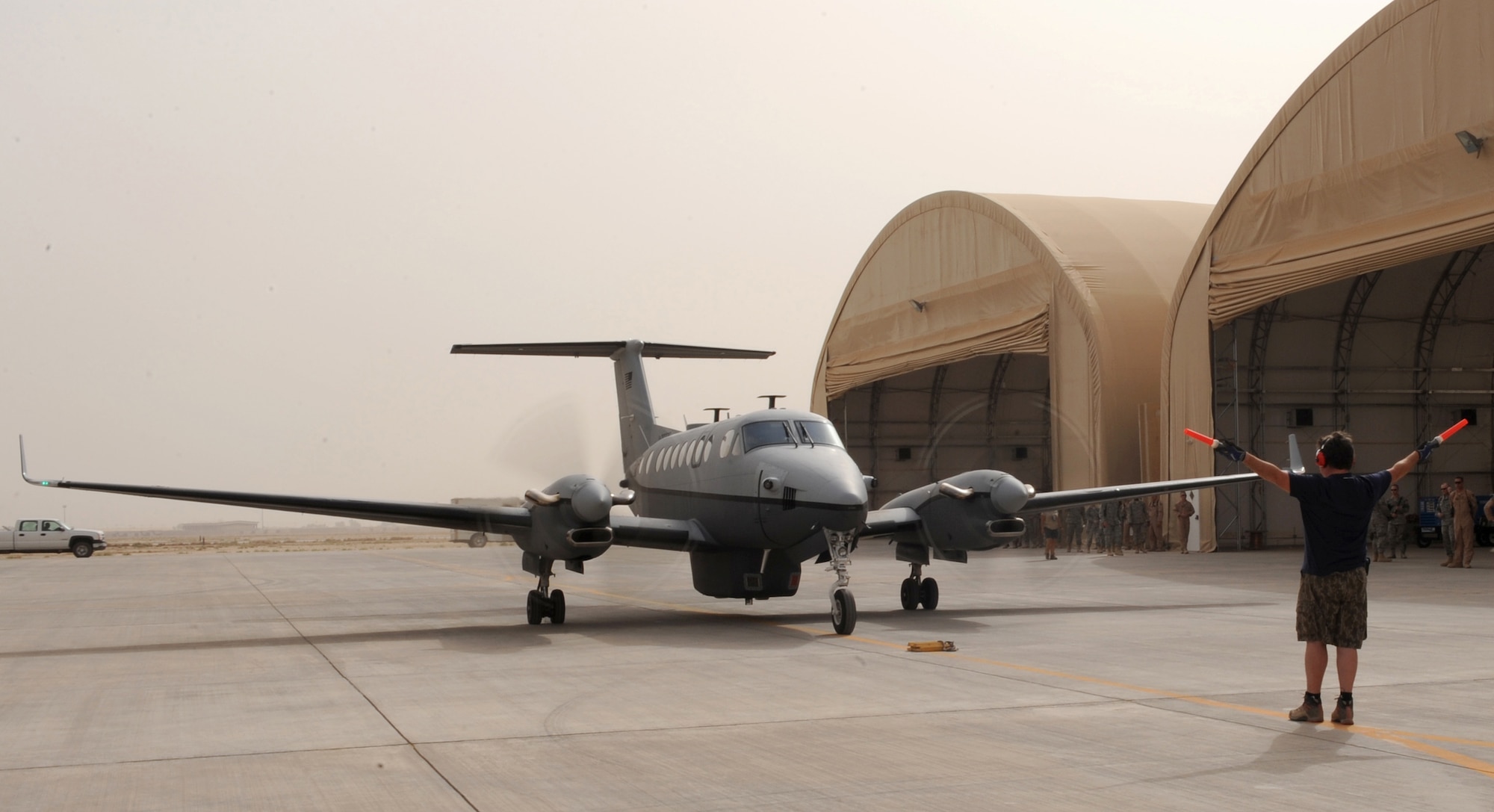 JOINT BASE BALAD, Iraq — The Air Force's new MC-12 Liberty aircraft, and the first one deployed in-theater, taxies into an aircraft hanger here June 8. A medium-altitude manned special-mission turboprop aircraft designed for intelligence, surveillance and reconnaissance, MC-12 aircraft will operate from here in support of Coalition and joint ground forces. (U.S. Air Force photo/Senior Airman Tiffany Trojca)