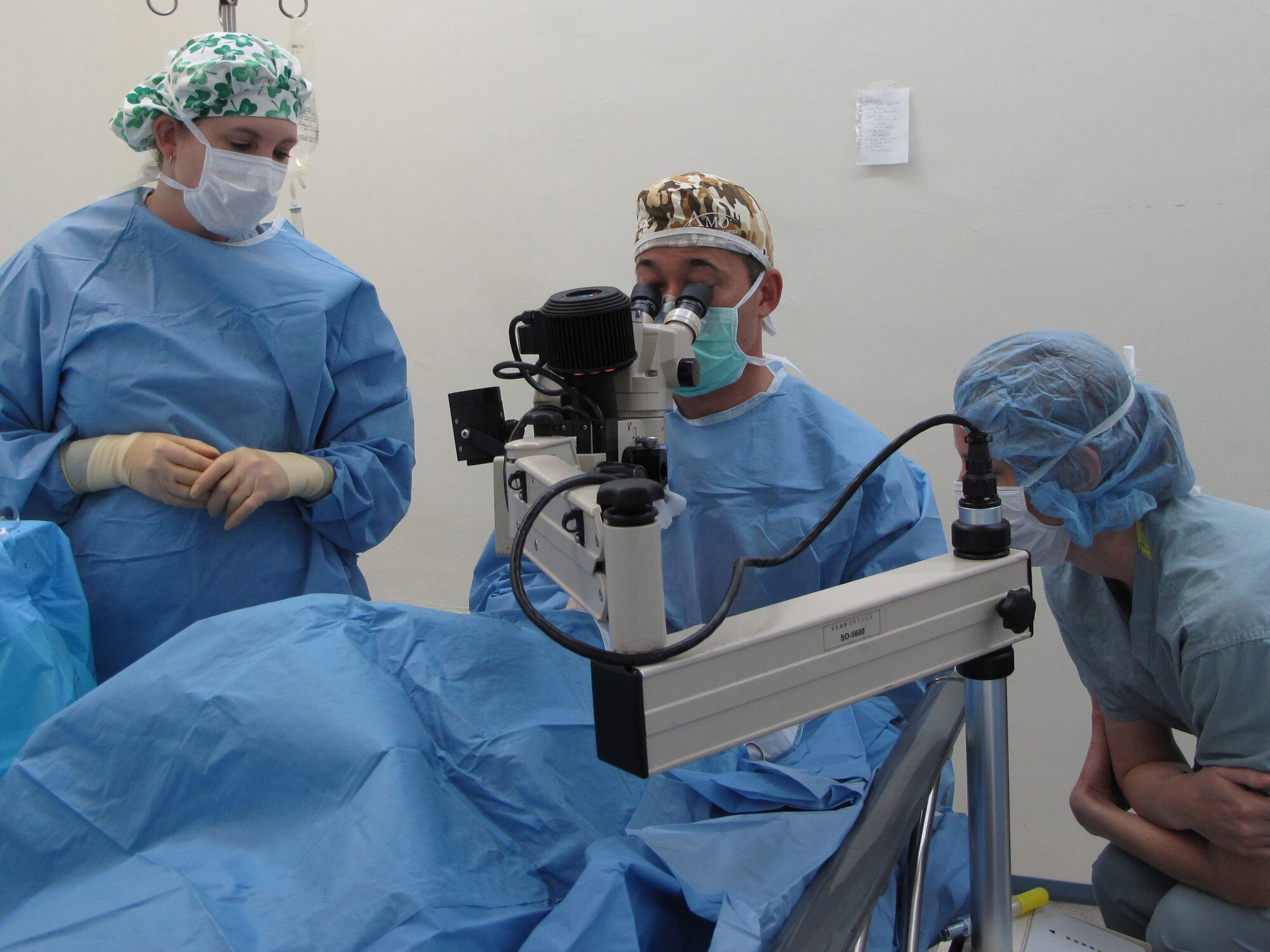 Lt. Col. (Dr.) Charles Reilly (center), consultant to the Air Force Surgeon General for refractive surgery, performs eye surgery on a Panamanian patient, assisted by Master Sgt. Jennifer Whitmore (left) and Capt. (Dr.) Kristine Pierce, May 13 at La Regional Hospital, La Chorrera, Panama. The group was part of a six-member team from the 59th Medical Wing's Ophthalmology Flight that went on a 13-day humanitarian mission to Panama to perform eye surgery and exams on Panamanian patients who could not afford to pay for their medical care.  (U.S. Air Force photo)                                                              