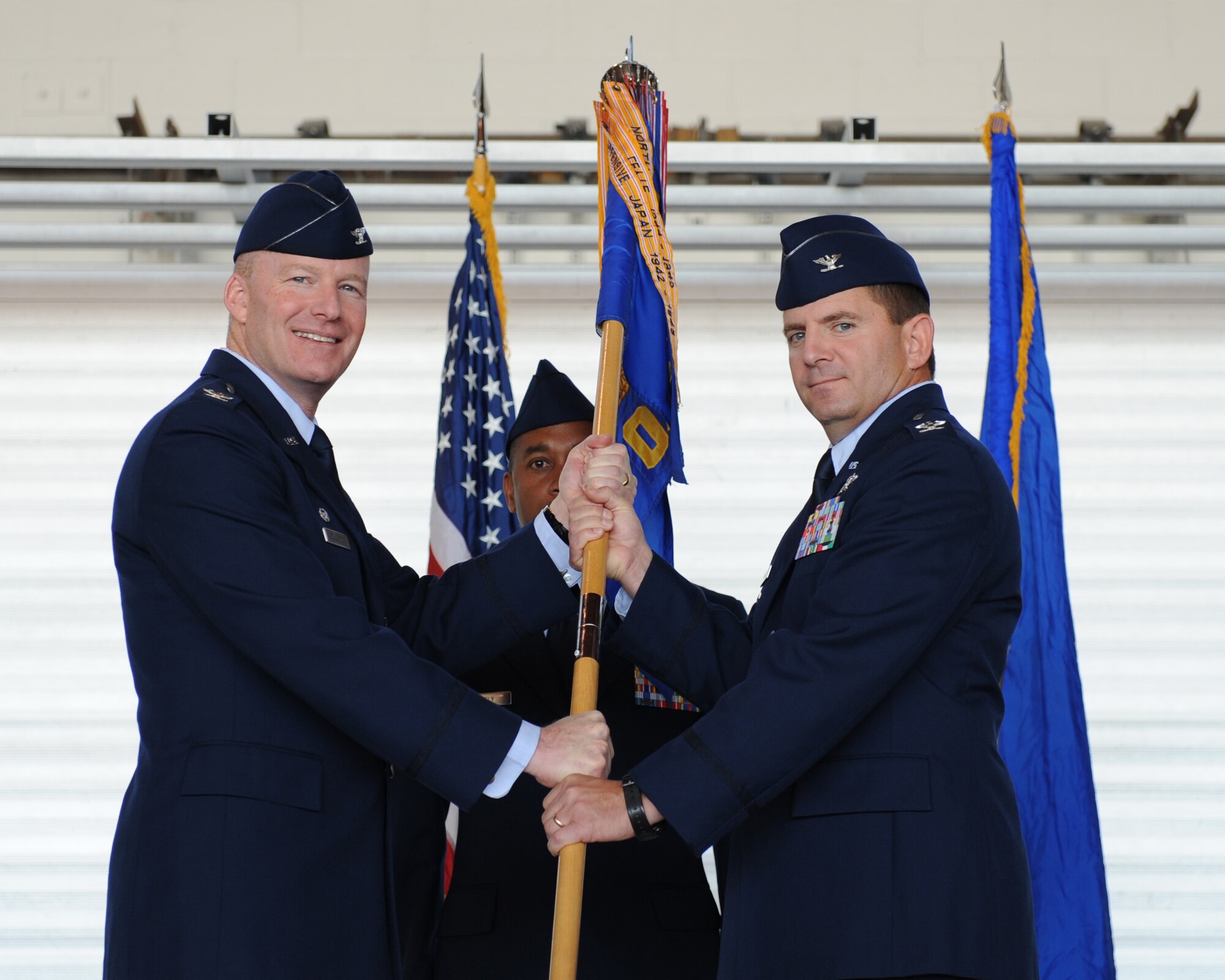 SCOTT AIR FORCE BASE, Ill. -- Col. Gary Goldstone, 375th Airlift Wing commander, passes the 375th Operations Group guidon to Col. Terry Ward, the new 375th Operations Group commander, Friday in Hangar 3. Colonel Ward took command from Col. Curtis Connell, who moved to Washington, D.C.(U.S. Air Force photo/Staff Sgt. Paul Villanueva II)
