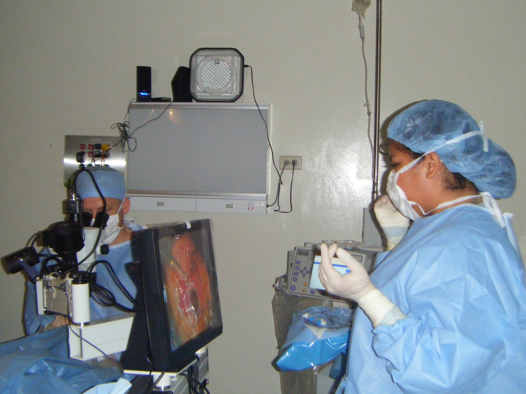 Airman 1st Class Joany Nunez, ophthalmic technician (right), observes eye surgery  being performed by Col. (Dr.) Jonathon Briggs, ophthalmologist, May 11 at La Regional Hospital, La Chorrera, Panama.  The two were part of a six-member that from the 59th Medical Wing Ophthalmology Flight that went on a 13-day humanitarian mission to Panama to perform eye surgeries and exams on Panamanian patients who could not afford to pay for their health care.  The team performed 145 successful surgeries during their mission.  (U.S. Air Force Photo) 