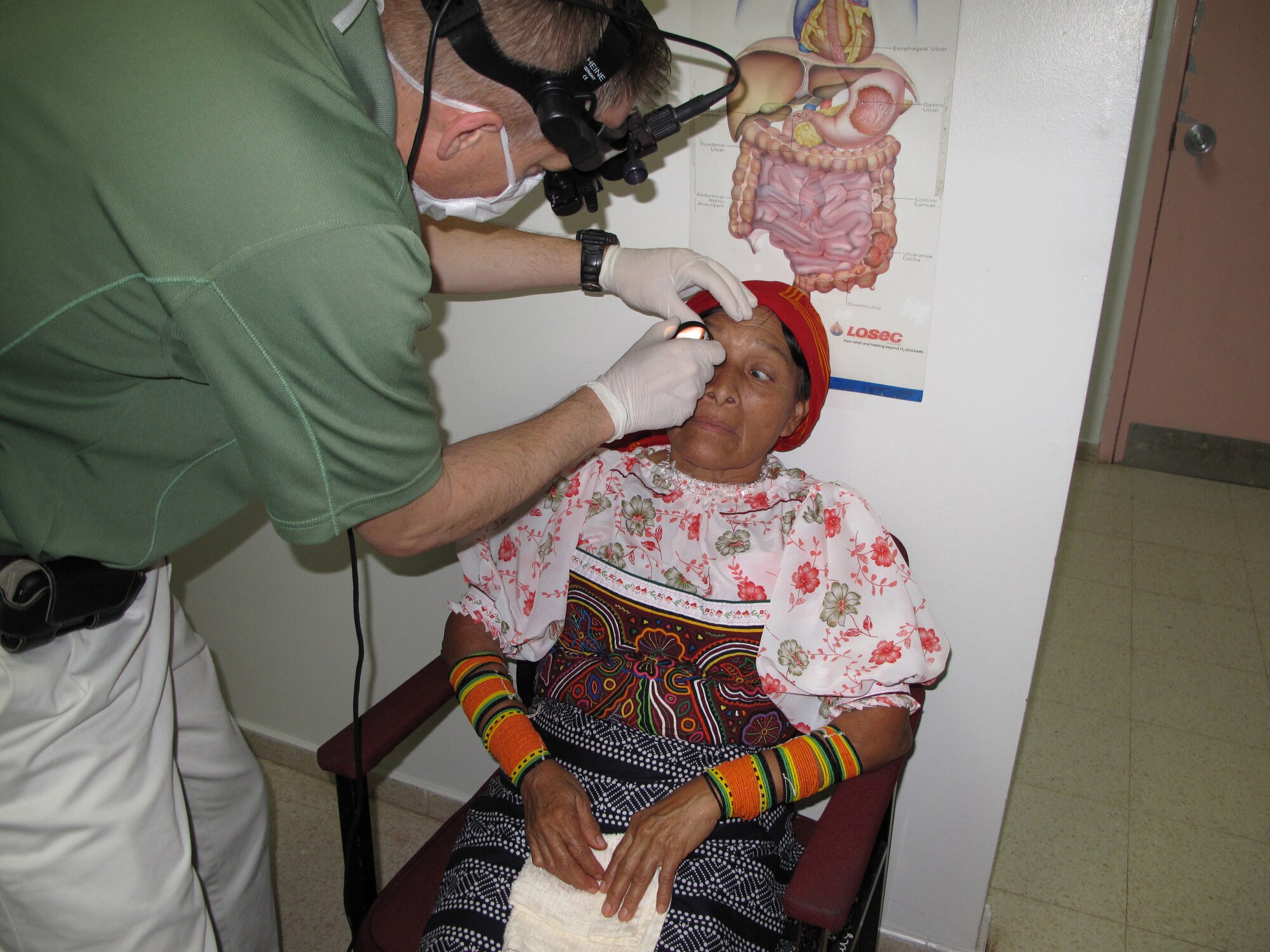 Col. (Dr.) Jonathan Briggs, ophthalmologist, 59th Surgical Specialties Squadron, performs an eye screening on a Panamanian woman on May 11 at La Regional Hospital, La Chorrera, Panama.  A six-member team from the 59th Medical Wing's Ophthalmology Flight went on a 13-day humanitarian mission to Panama to perform eye surgeries and exams on Panamanian patients who cannot afford to pay for their medical care.  (U.S. Air Force photo)                                