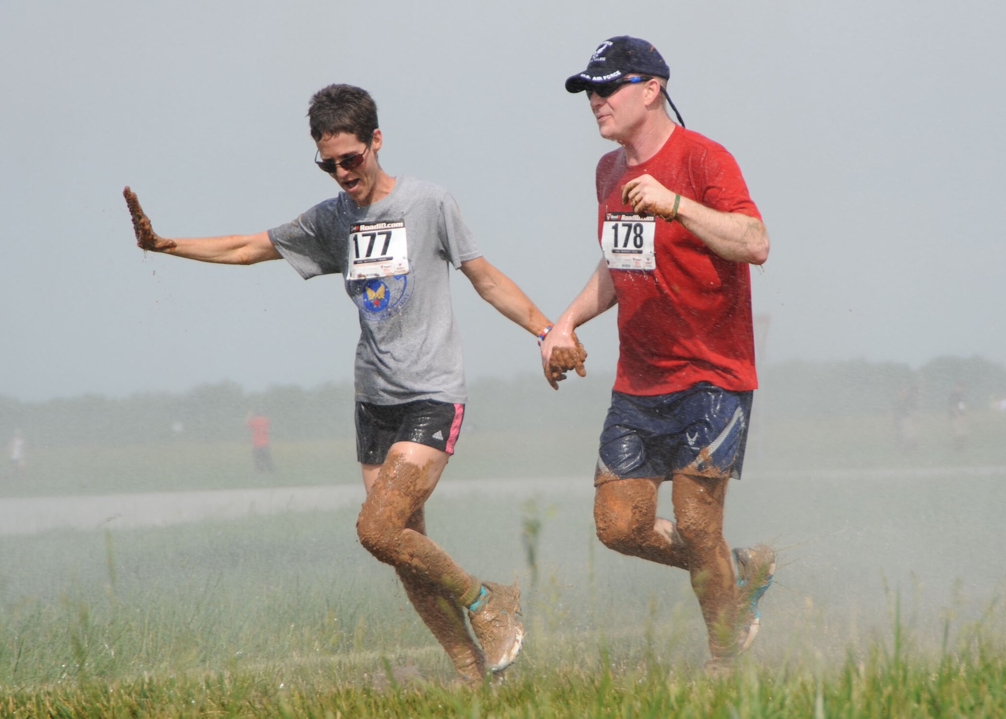SCOTT AIR FORCE BASE, Ill. -- Col. Gary Goldstone, 375th Airlift Wing commander, and his wife, Mary, who placed second in her age category, get sprayed down by a fire truck after negotiating the 3.2 mile course. (U.S. Air Force photo/ Tech. Sgt. Michelle Larche)