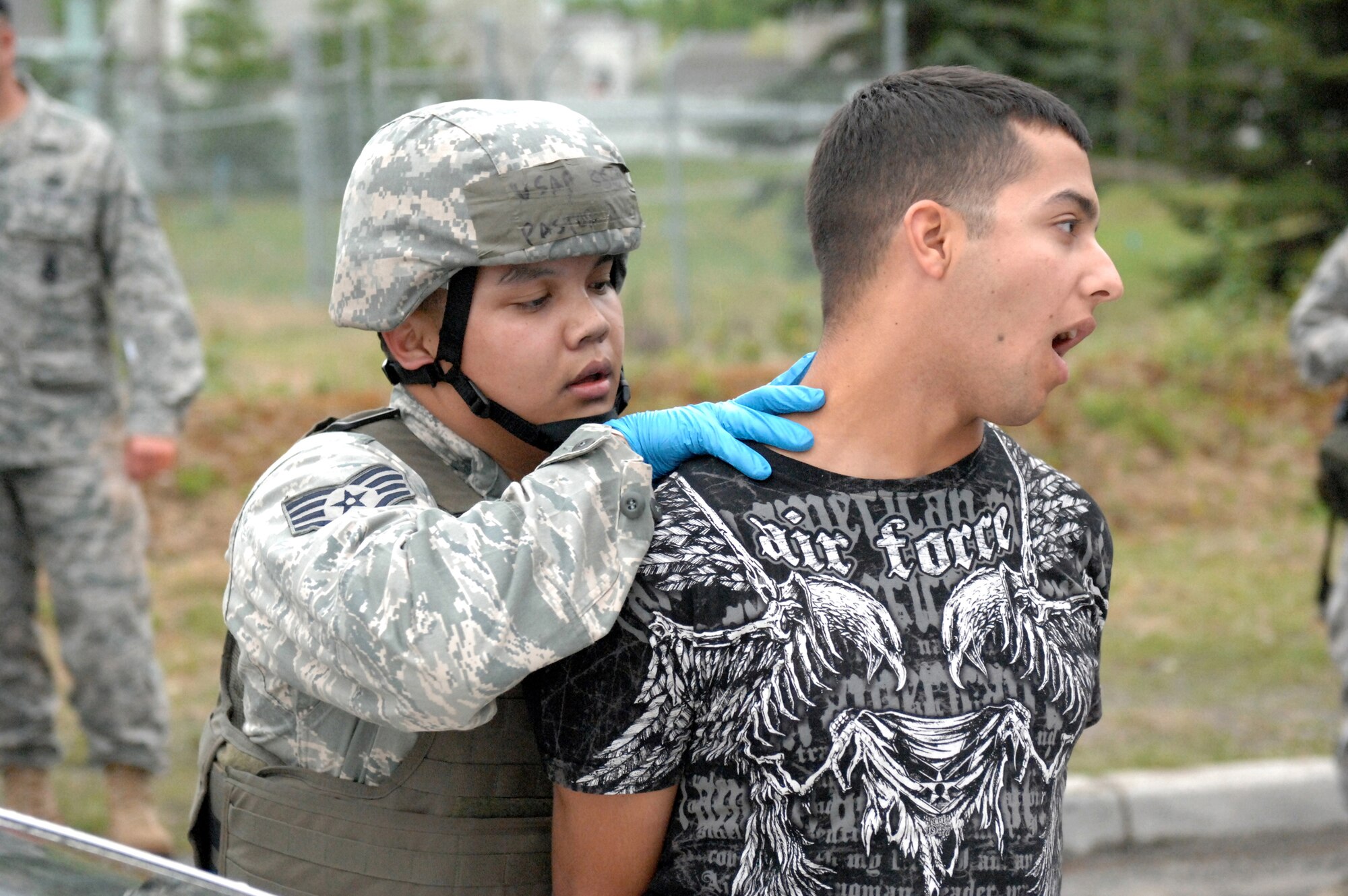 ELMENDORF AIR FORCE BASE, Alaska -- Staff Sgt. Mark Pastor secures and searches a demonstrator who breached the Boniface Gate during an Operational Readiness Inspection June 4. Pastor is a member of the 3rd Security Forces Squadron. This portion of the inspection was a part of the second phase, which tested the 3rd Wing's ability to survive and operate in a combat environment. (U.S. Air Force photo/Tech. Sgt. Brian Smith)