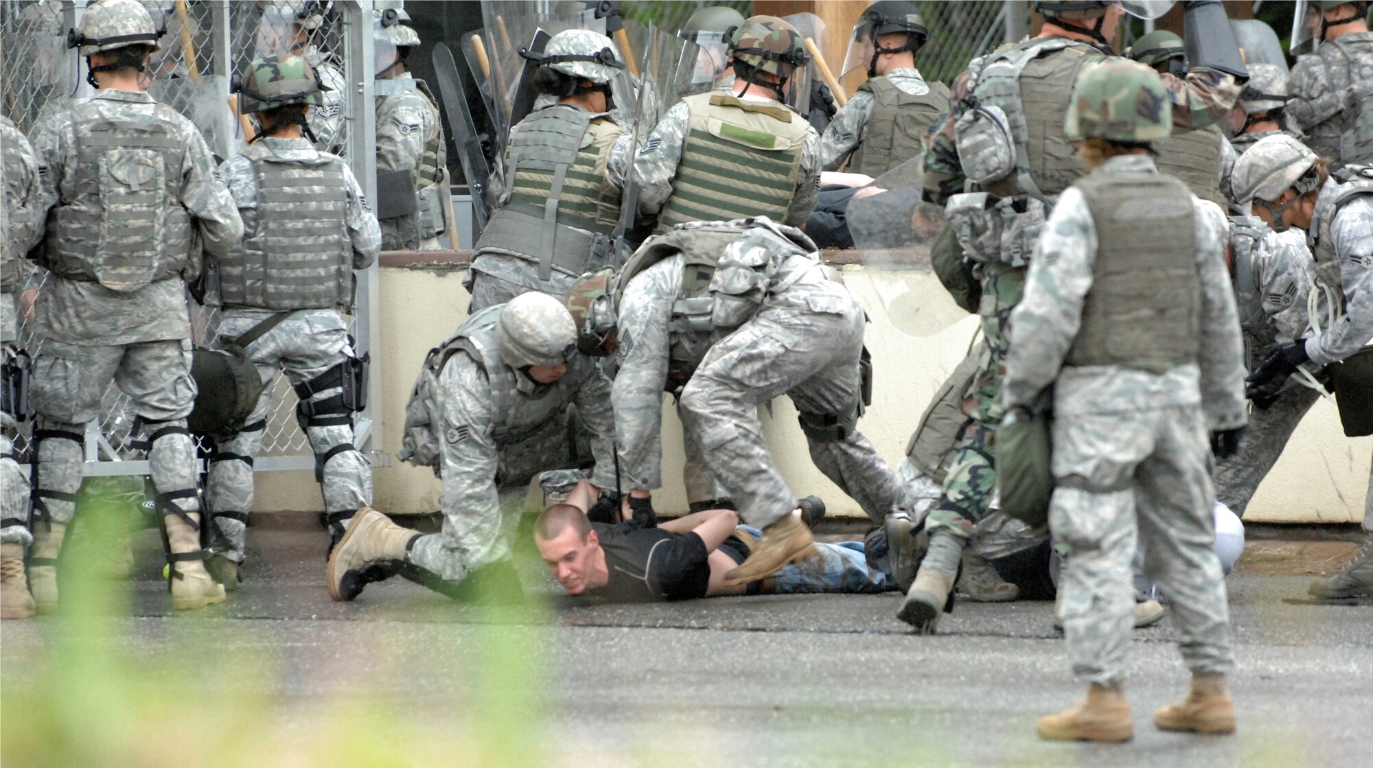 ELMENDORF AIR FORCE BASE, Alaska -- Members of the 3rd Security Forces Squadron subdue demonstrators who breached the Boniface Gate during a Operational Readiness Inspection June 4. This portion of the inspection was a part of the second phase, which tested the 3rd Wing's ability to survive and operate in a combat environment. (U.S. Air Force photo/Tech. Sgt. Brian Smith)