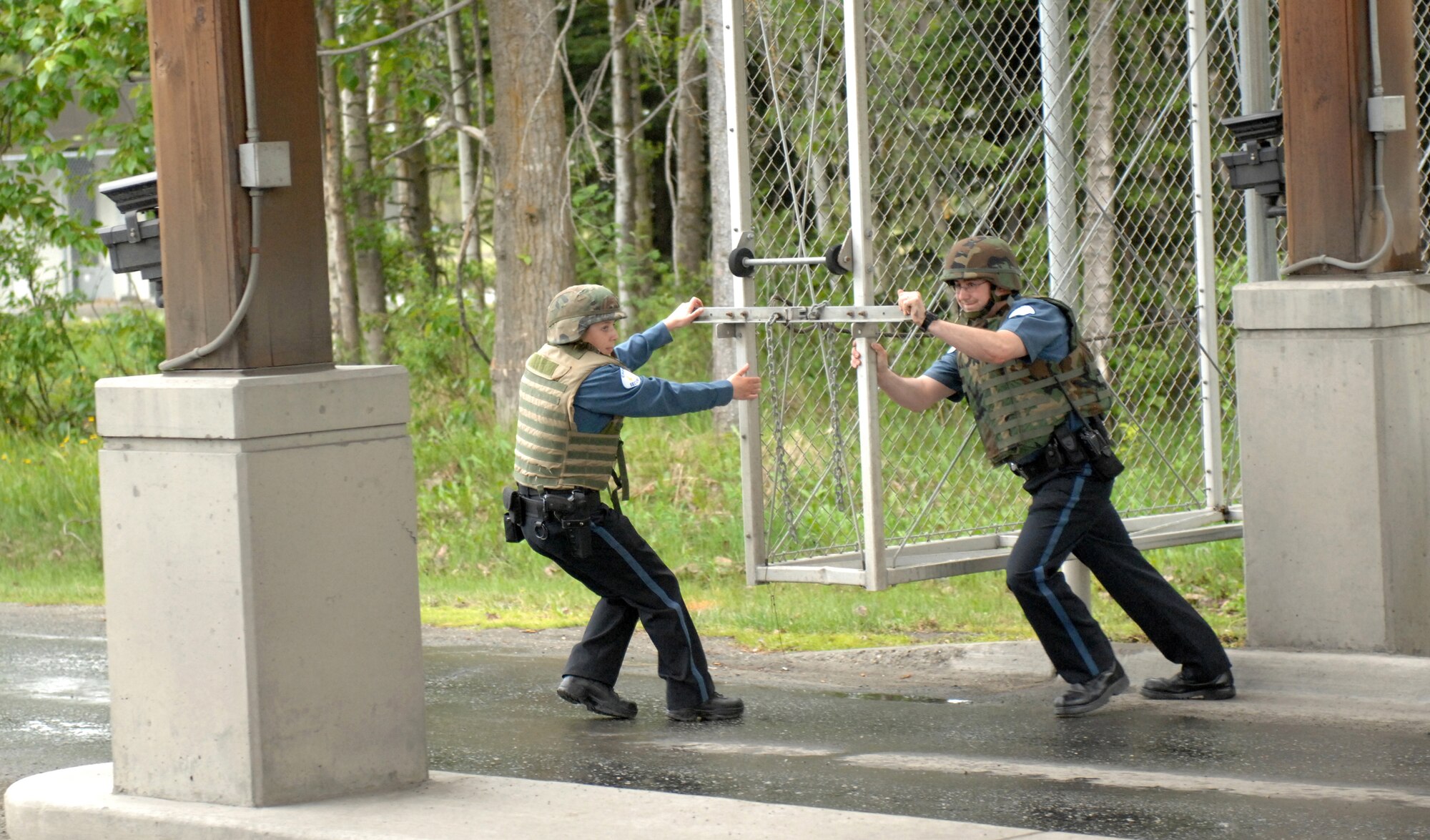 ELMENDORF AIR FORCE BASE, Alaska -- Members of the 3rd Security Forces Squadron close the outbound Boniface Gate during an Operational Readiness Inspection June 4. This portion of the inspection was a part of the second phase, which tested the 3rd Wing's ability to survive and operate in a combat environment. (U.S. Air Force photo/Tech. Sgt. Brian Smith)