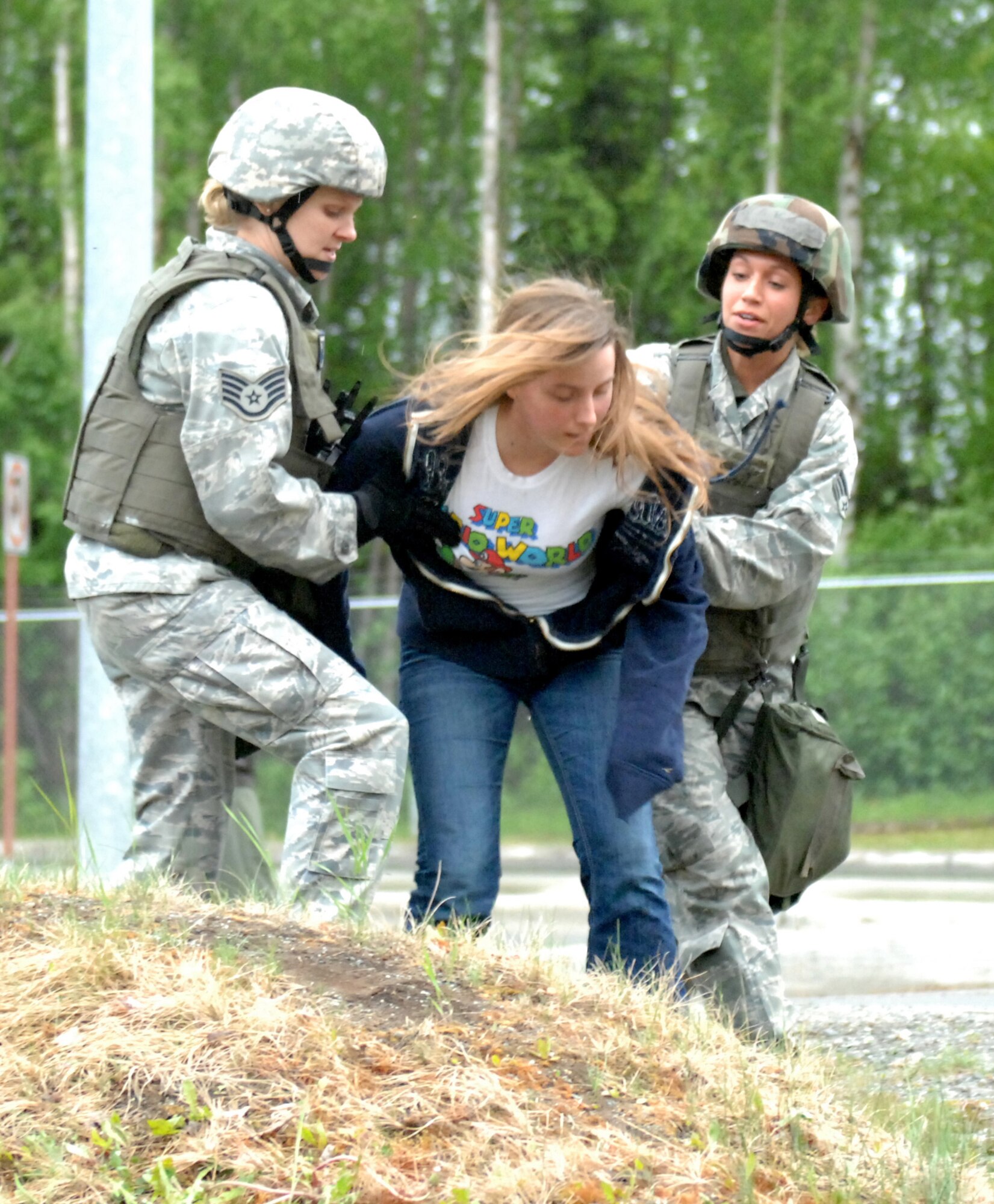 ELMENDORF AIR FORCE BASE, Alaska -- Members of the 3rd Security Forces Squadron handcuff demonstrators who breached the Boniface Gate during the 2009 Operational Readiness Inspection June 4. This portion of the inspection was a part of the second phase, which tested the 3rd Wing's ability to survive and operate in a combat environment. (U.S. Air Force photo/Tech. Sgt. Brian Smith)