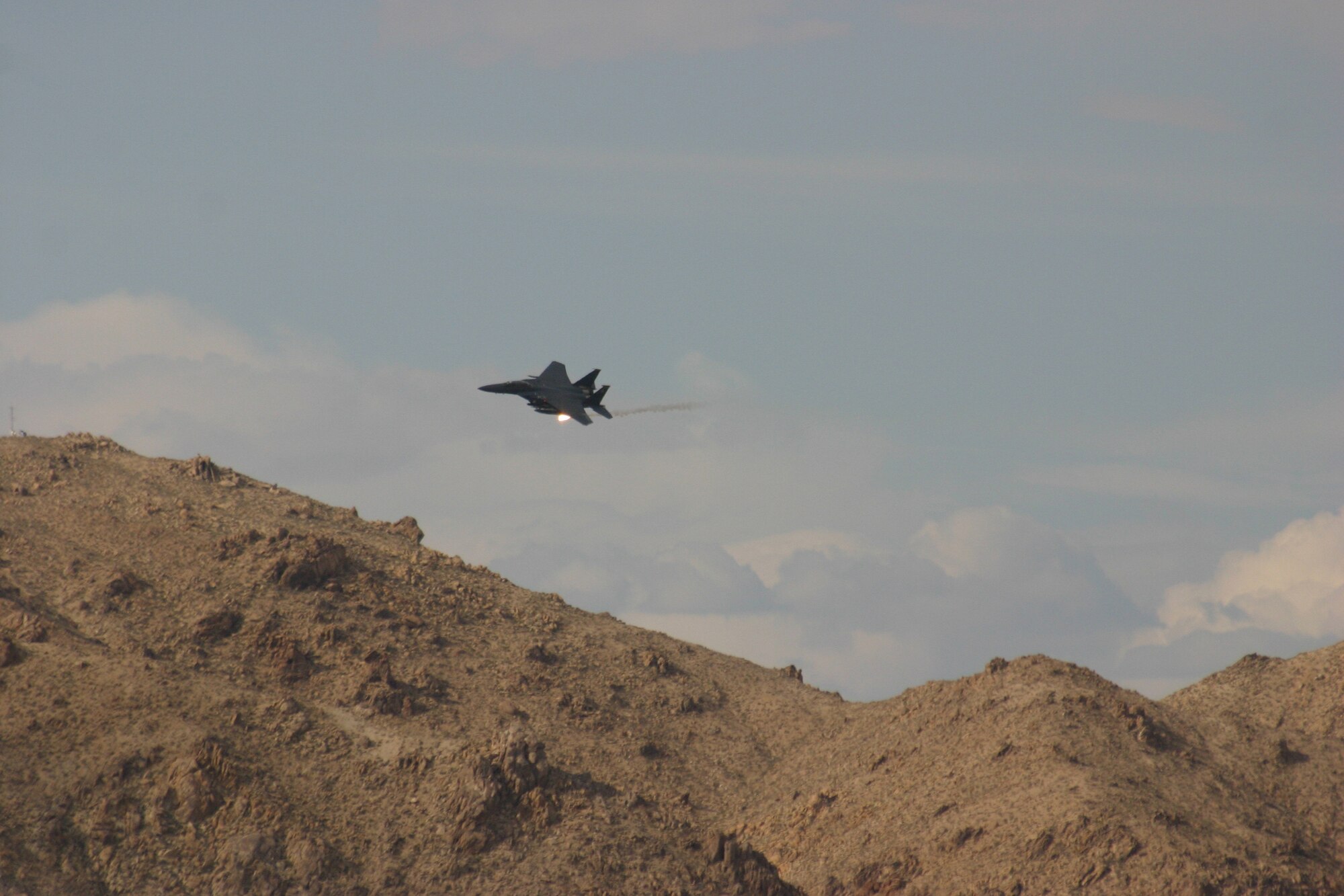 An Air Force F-15E from the 335th Fighter Squadron at Seymour Johnson AFB, N.C., participates in joint air attack team  training during GFW and NTC rotation 09-07 at Ft. Irwin, Calif.  (JFIIT photo/Casey Bain)
