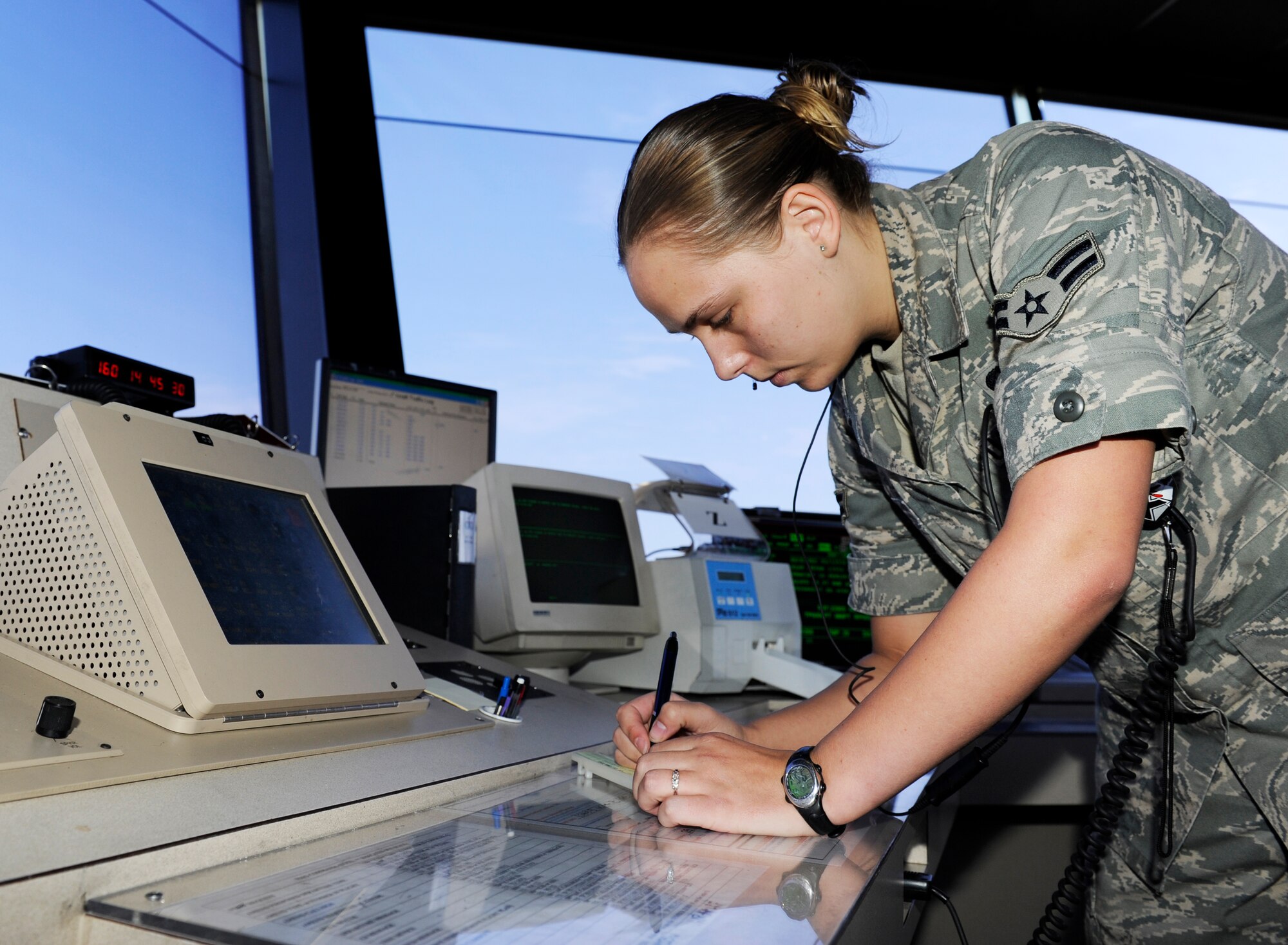 Airman 1st Class Ashley Heidel, a 19th Operations Support Squadron air traffic control journeyman, issues clearance to departuring aircrafts in the control tower at Little Rock Air Force Base June 9, 2009. (US Air Force photo by Airman Lausanne Pacheco)