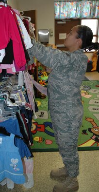 Airman 1st Class Carolmesha Stroud, 341st Logistics Readiness Squadron traffic management apprentice, looks for clothes to fit her goddaughter May 28 at the Airman's Attic. (U.S. Air Force photo/Senior Airman Dillon White)