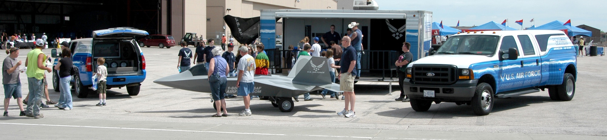 A crowd gathers around the 343rd Recruiting Squadron’s booth featuring an F-22 mini-jet during the recent Dakota Thunder 2009 Open House and Air Show at Ellsworth Air Force Base, S.D. The event generated several leads for the recruiting squadron while increasing awareness about Air Force opportunities in the Rapid City area. More than 40,000 attended the open house and air show to see the U.S. military's air power firsthand and speak with servicemembers about what they do and why they serve.  (U.S. Air Force photo/Tech. Sgt. David J. McCarrison)