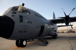 Staff Sgt. Karon Evans washes the flight deck windows on a Hurricane Hunter WC-130J Hercules before a training mission leaving St. Croix, V.I. Sergeant Evans is a crew cheif assigned to the 403rd Wing from Keesler, AFB, Miss. The training mission covered the Air Force Reserve Command's weather reconnaissance mission. (U.S. Air Force photo/Staff Sgt. Desiree Palacios)