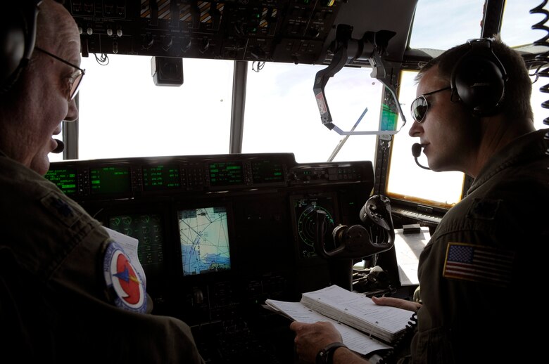 Lt. Col. Roger Gardner and Lt. Col. Louis Patriquin review a checklist during a training mission on a WC-130J Hercules to St. Croix, V.I. from Keesler Air Force Base, Miss. Colonel Gardner is the aircraft commander and Colonel Patriquin is the 403rd Operations Group commander. The mission covered the Air Force Reserve Command's weather mission as they enter Hurricane Season, which began June 1. (U.S. Air Force photo/Staff Sgt. Desiree N. Palacios)