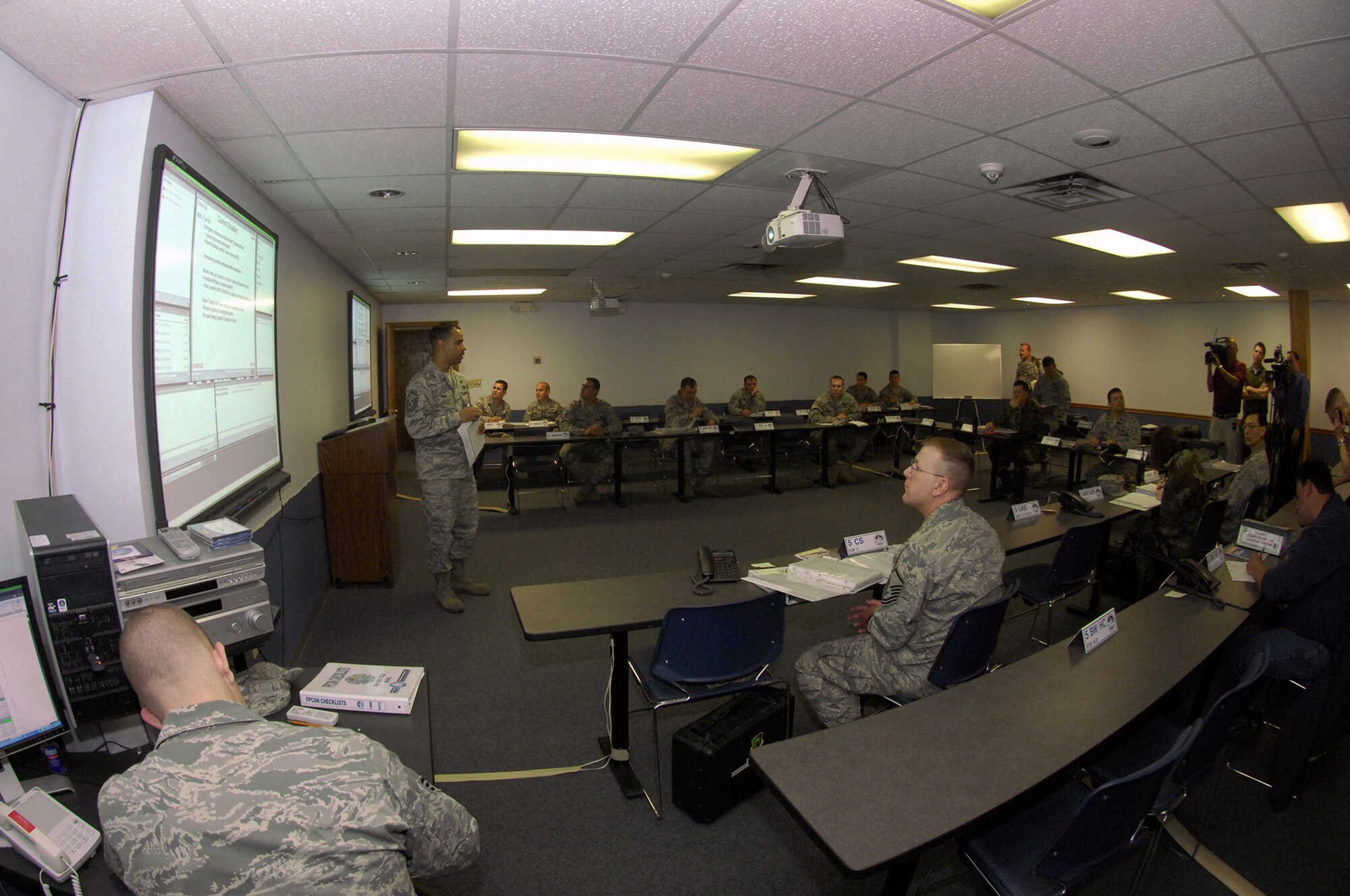 MINOT AIR FORCE BASE, ND -- Master Sgt. Phillip Pugh, readiness and emergency management superintendant of the 5th Civil Engineer Squadron, briefs the emergency operations center representatives during a joint anti-terrorism exercise here, June 3.  The exercise involved several agencies, including the base, Bismarck Army National Guard, Minot Fire and Rescue Service, and the Minot Police Department.  The purpose of the exercise was to ensure vigilance and readiness in order to defeat possible terrorist threats wherever they may occur. (U.S. Air Force Photo by Staff Sgt. Miguel Lara III)