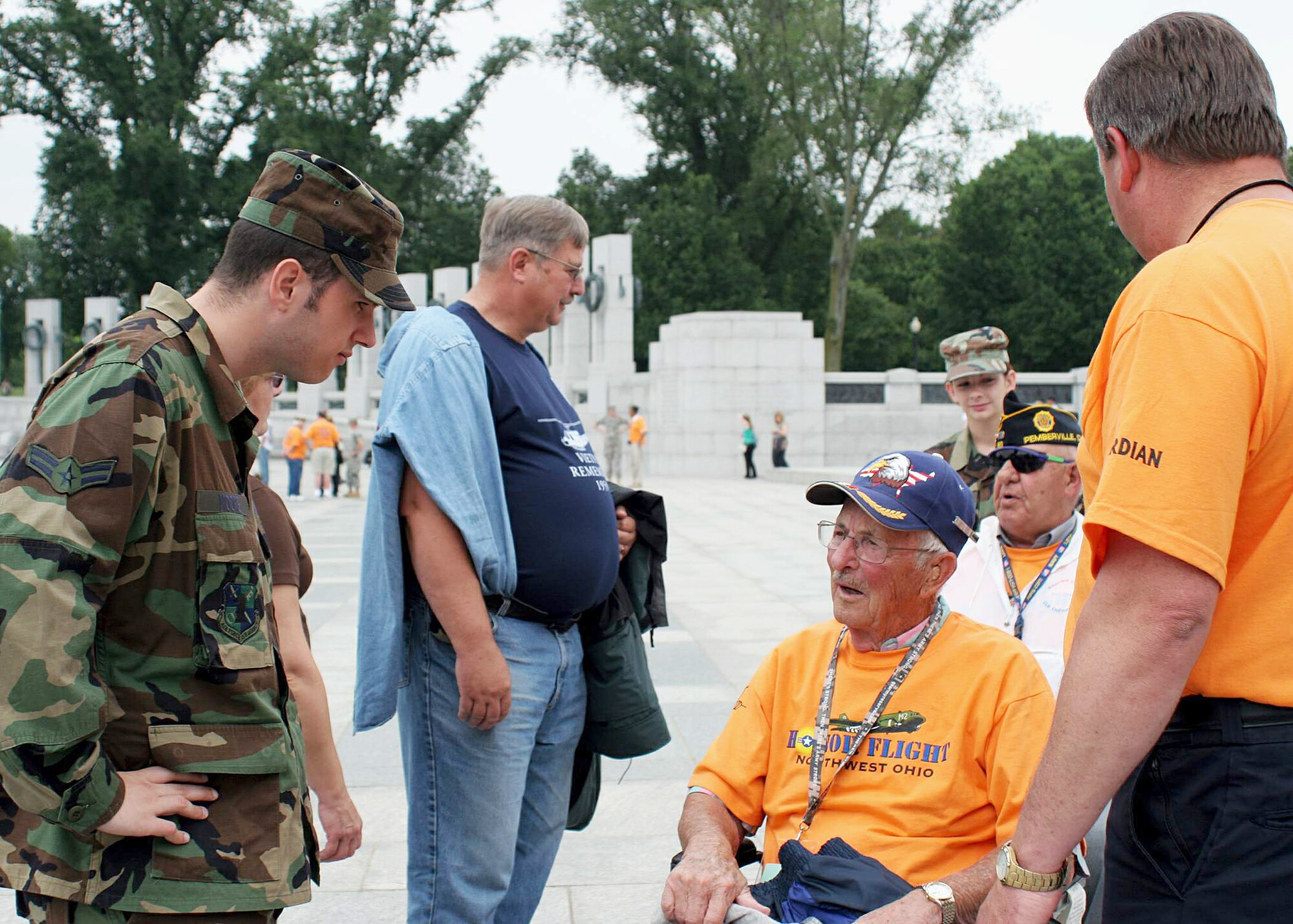 Airman 1st Class Kyle Moore listens as former Army Cpl. Carl Taber stops at the World War II memorial to describe the conditions in the North African theater of operations May 27 in Washington, D.C. Mr. Taber, also a veteran of the Battle of the Bulge, was on his way to see where the major Atlantic battles were recognized at the memorial when Airman Moore asked about his experiences during the war. Airman Moore is a network analyst assigned to the 22nd Intelligence Squadron at Fort Meade, Md. (U.S. Air Force photo/Tech. Sgt. Karen J. Tomasik) 
