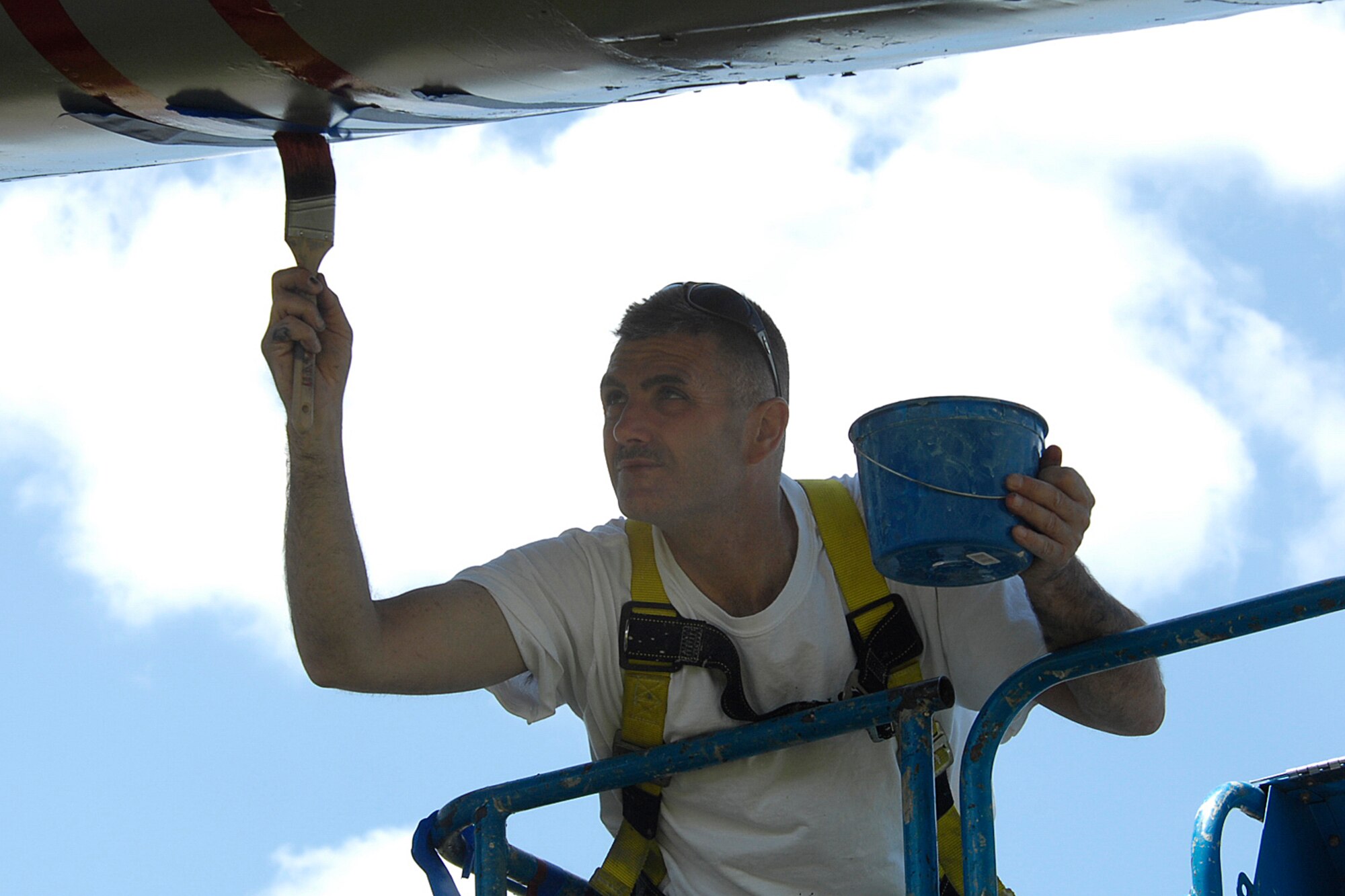 HANSCOM AIR FORCE BASE, Mass. –James Gouveia of R. J. McAuliffe Painting, Lowell, Mass., paints stripes on Hanscom’s F-86 Sabre static display on May 29. Both the F-86 and the P-40 displays are getting makeovers, complete with fresh coats of paint and some corrosion repair work to preserve the base’s heritage displays. (U.S. Air Force photo by Linda LaBonte Britt) 