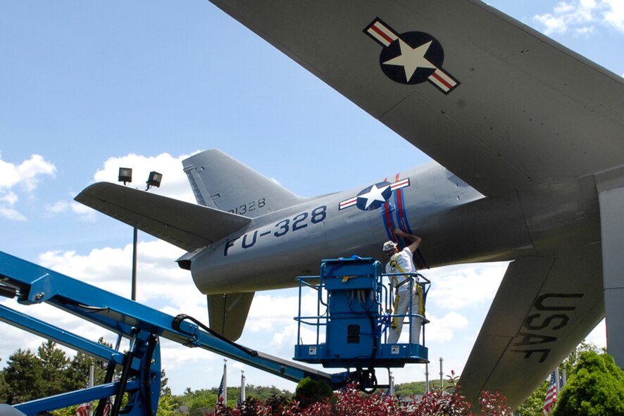 HANSCOM AIR FORCE BASE, Mass. –James Gouveia of R. J. McAuliffe Painting, Lowell, Mass., paints stripes on Hanscom’s F-86 Sabre static display on May 29. Both the F-86 and the P-40 displays are getting makeovers, complete with fresh coats of paint and some corrosion repair work to preserve the base’s heritage displays. (U.S. Air Force photo by Linda LaBonte Britt) 