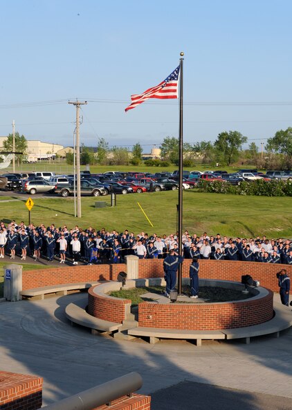 MINOT AIR FORCE BASE, ND – Members of the 91st Missile Wing (91MW) salute the flag as reveille sounds prior to the start of their formation run here June 5. U.S. Air Force Space Command designated June as fitness month, and the 91st MW kicked it off by running from their headquarters to the flight line--and back, encompassing a distance of two miles. (US Air Force photo by Staff Sgt. Keith Ballard)