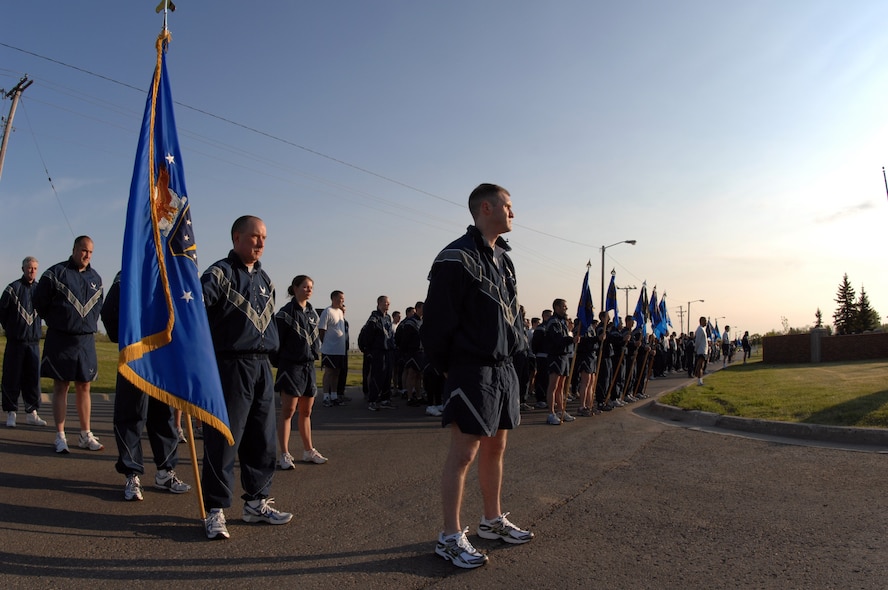 MINOT AIR FORCE BASE, ND – Members of the 91st Missile Wing standby prior to reveille sounding here, June 5. U.S. Air Force Space Command designated June as fitness month, and the 91st MW kicked it off by running from their headquarters to the flight line--and back, encompassing a distance of two miles. (U.S. Air Force photo by Staff Sgt. Angel Gallardo)
