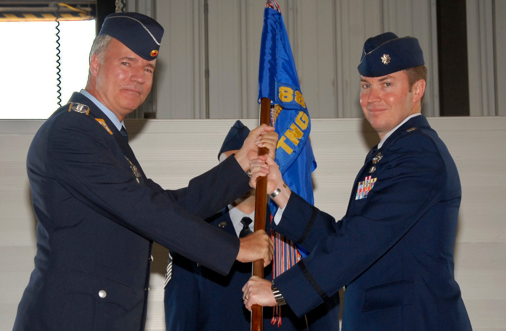 Lt. Col. James Robinson, right, accepts command of the 88th Fighter Training Squadron June 18 during a ceremony June 4. 80th Operations Group Commander Axel Pohlmann officiated the event. The outgoing commander was German air force Lt. Col. Christian Rode. (U.S. Air Force photo/Harry Tonemah)