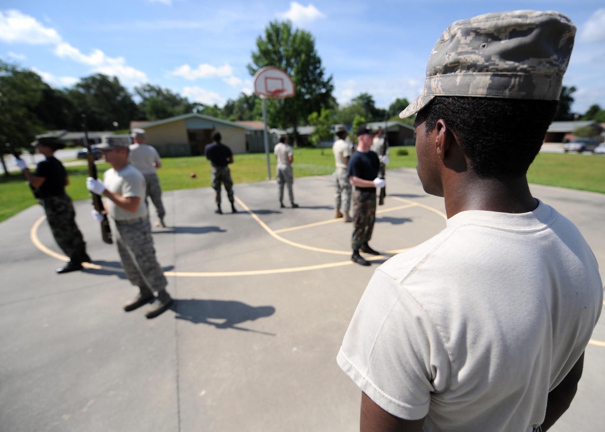Airman 1st Class Todd Tolbert calls out instructions for honor guard rifle team members outside the Charleston AFB honor guard headquarters building at Hunley Park June 3. Airman Tolbert is an Flightline Service Center Clerk with the 437th Logistics Readiness Squadron. (U.S. Air Force photo/Senior Airman Timothy Taylor)
