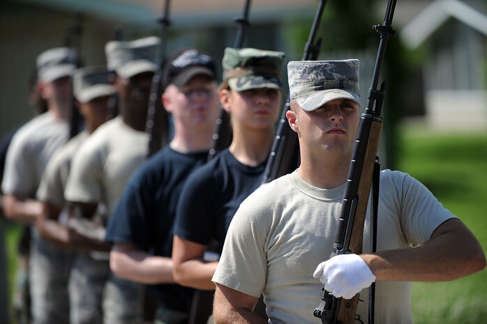 Airman 1st Class Joshua Walters and other honor guard members run through rifle drills outside the Charleston AFB honor guard headquarters building at Hunley Park June 3. Members from the Charleston, Shaw, McChord and Seymour Johnson AFBs gathered to train at Charleston AFB June 1 to 10. Airman Walters is a Structural Maintenance apprentice from Shaw AFB. (U.S. Air Force photo/Senior Airman Timothy Taylor) 