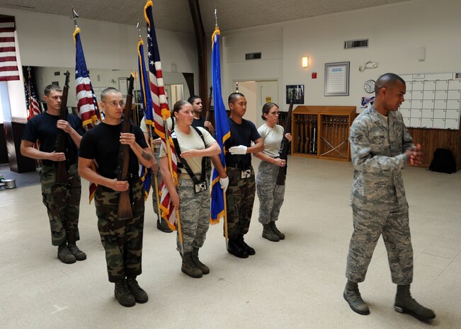 Senior Airman Paul Benjamin instructs honor guard members on the proper method for posting the colors June 3. The Charleston AFB honor guard hosted the Air Force's Honor Guard Mobile Training Course June 1 to 10. Airman Benjamin is a Formal Training Flight Instructor for the Air Force Honor Guard Headquarters. (U.S. Air Force photo/Senior Airman Timothy Taylor)