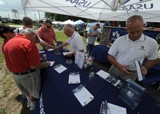 Charleston community members sign up for gift cards at the United States Automobile Association booth during the Charleston AFB picnic here June 5. The picnic was the kickoff event for MatchUP, Air Mobility Command's summer program where players can win prizes by participating in base activities. (U.S. Air Force photo/Senior Airman Timothy Taylor)