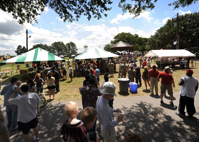 Airmen and members from the Charleston community stand in line as Airmen from the 437th Force Support Squadron serve food at the picnic grounds for the Charleston AFB picnic June 5. Families were able to register for MatchUP at the picnic for a chance to win valuable prizes and up to $10,000 cash. (U.S. Air Force photo/Senior Airman Timothy Taylor)