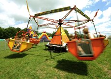 Children and parents take a spin on an amusement park ride at the base picnic grounds during the Charleston AFB picnic June 5. (U.S. Air Force photo/Senior Airman Timothy Taylor)