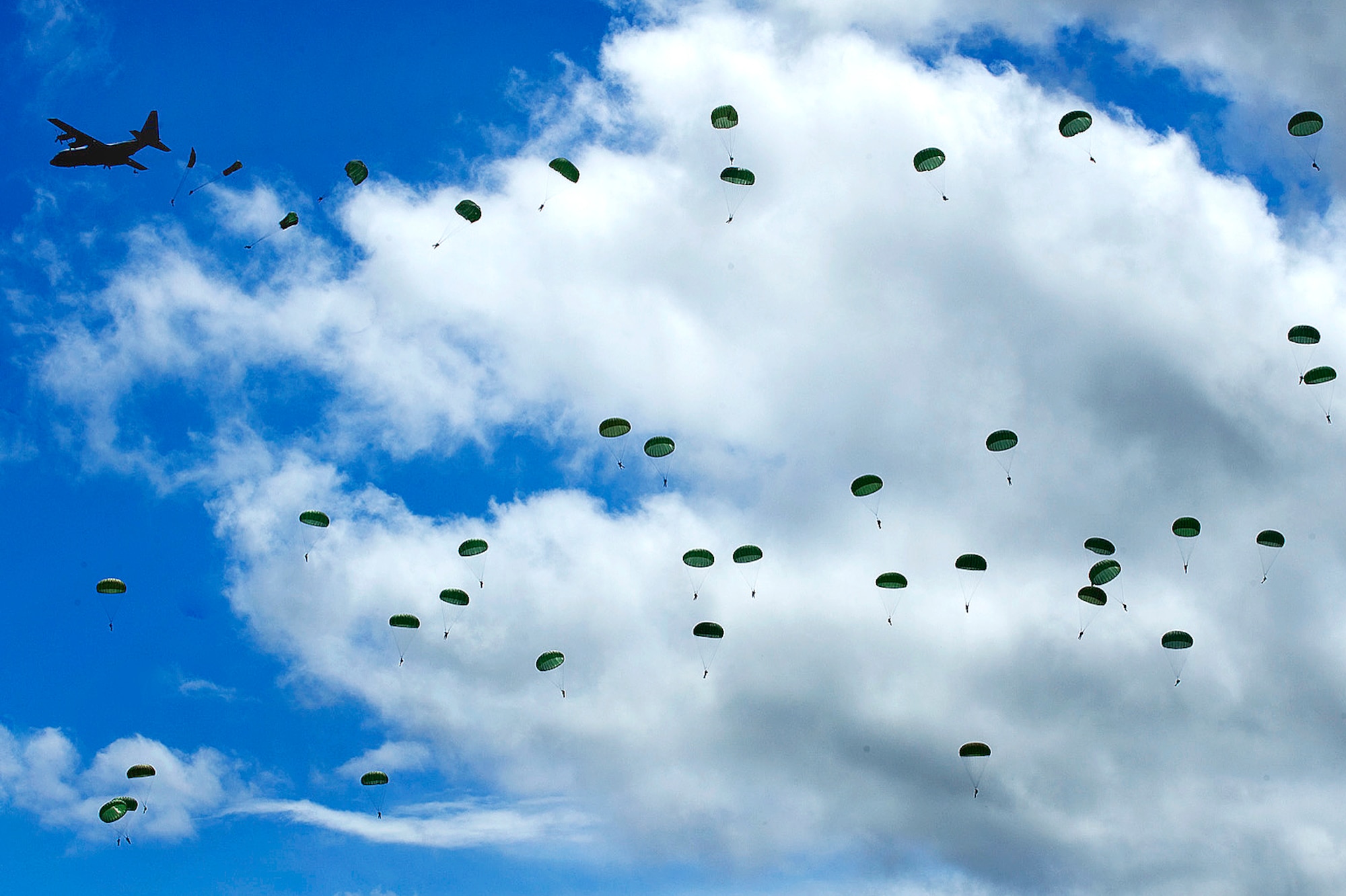 A Ramstein C-130 drops U.S. Army soldiers over Saint Mere Eglise June 7 as part of a re-enactment of the D-Day paratrooper jump that took place 65 years ago over the same area. U.S. Air Force photo by Master Sgt. Cecilio Ricardo)