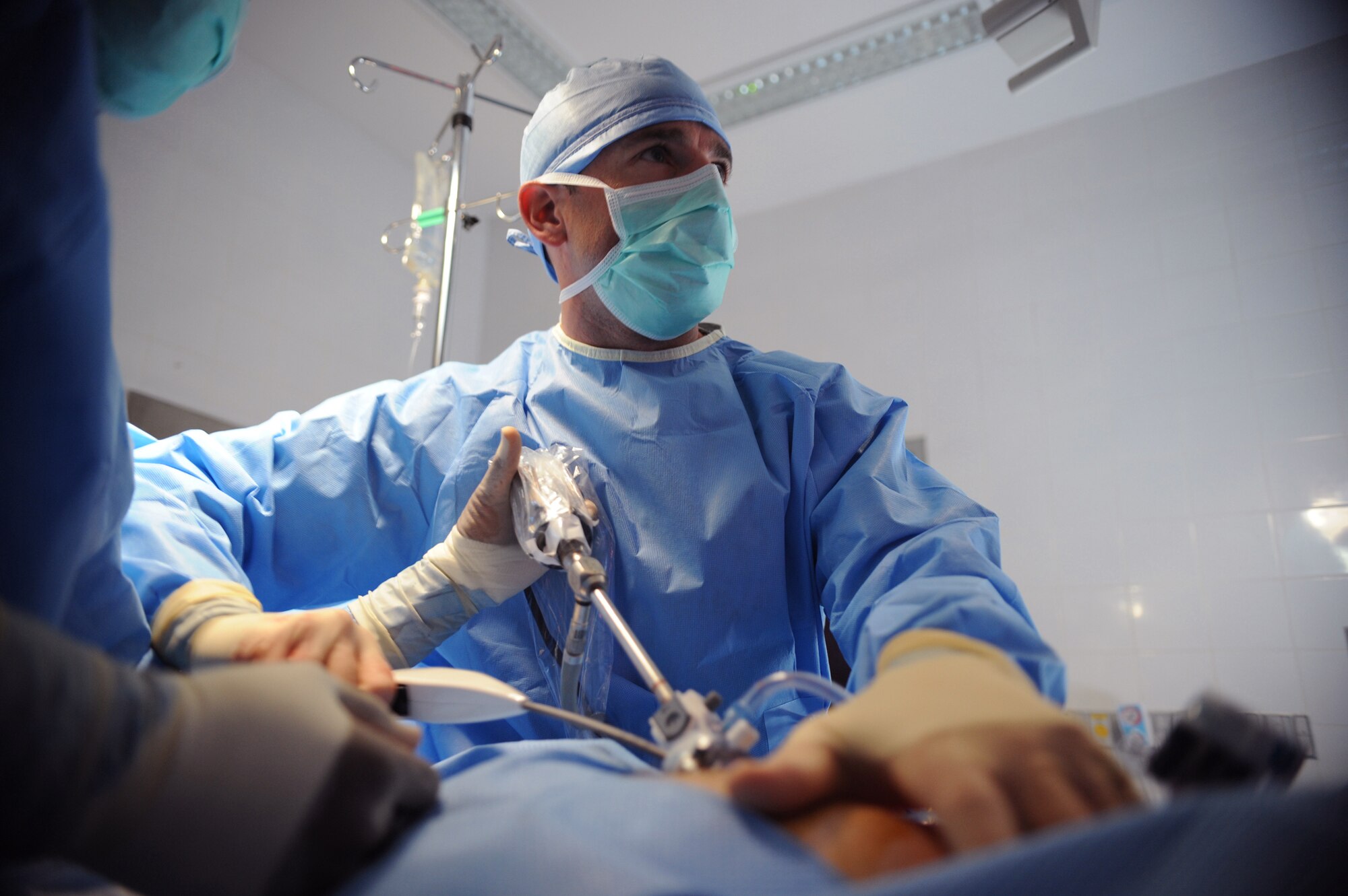 Major (Doctor) Brian Holt, 379th Expeditionary Medical Group General Surgeon, fixates a surgical prosthetic mesh over the reduced inguinal hernia with a laparoscopic tacker, June 5, 2009, at an undisclosed location in Southwest Asia.  This specific surgery allows the patient to return to duty quicker and with less pain.  The surgeries performed here range from elective to acute emergencies.  The surgical team provides treatment for patients coming in from all over the U.S. Central Command's Area of Responsibility.  Major Holt hails from St. Peters, Mo. and is deployed from Misawa Air Base, Japan in support of Operations Iraqi and Enduring Freedom and Combined Joint Task Force - Horn of Africa.  (U.S. Air Force photo/Senior Airman Andrew Satran/released)