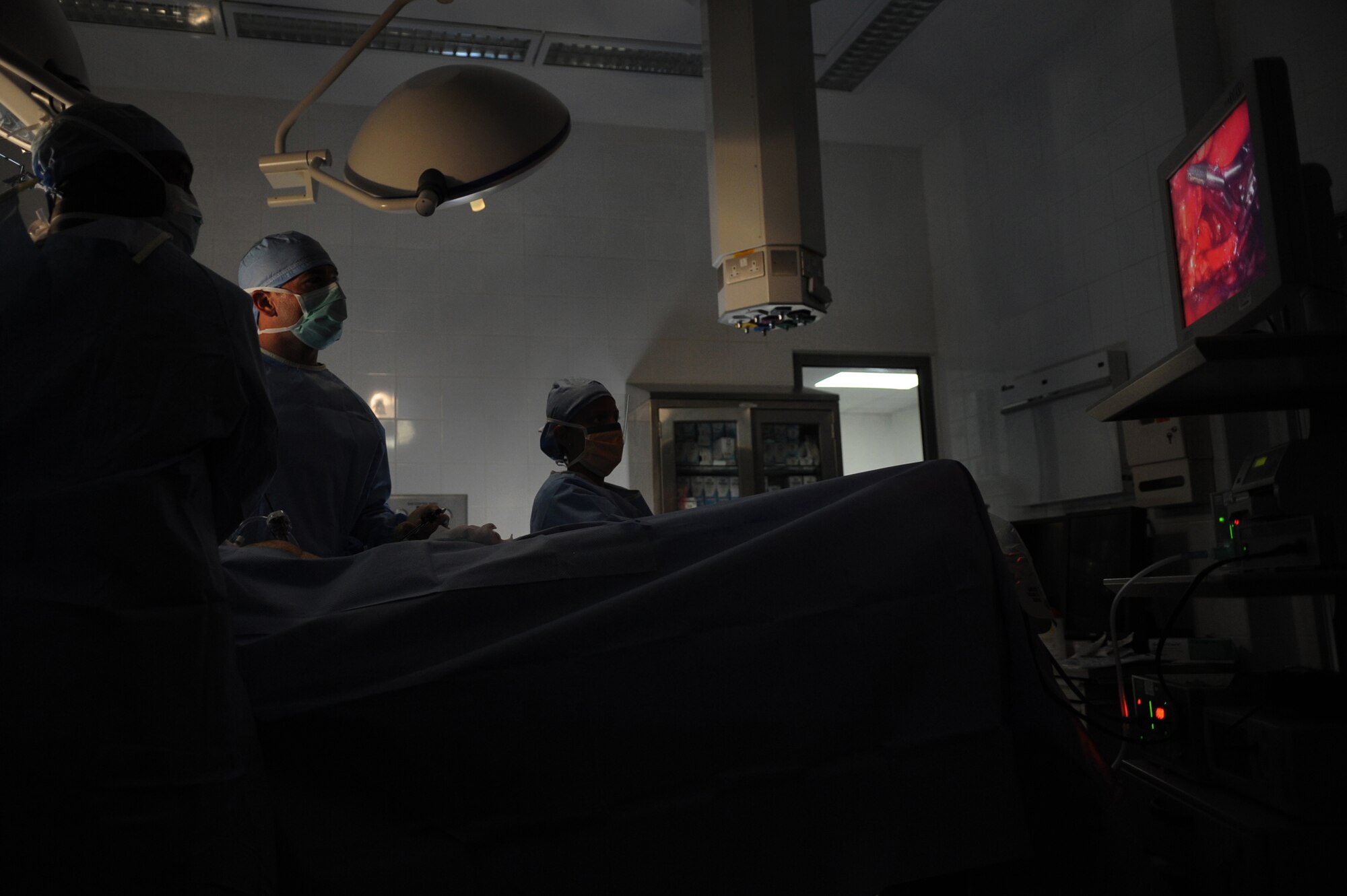 Staff Sgt. Troy Leach (left), a 379th Expeditionary Medical Group surgical clinic and respiratory therapist, uses a laparoscopic fiber optic camera to aid Major (Doctor) Brian Holt, 379th Expeditionary Medical Group General Surgeon, in an operation for an inguinal hernia as Staff Sgt. Vanessa Clark stands by, June 5, 2009 at an undisclosed location in Southwest Asia.  This specific surgery allows the patient to return to duty quicker and with less pain.  The surgeries performed here range from elective to acute emergencies.  The surgical team provides treatment for patients coming in from all over the U.S. Central Command's Area of Responsibility.  Sergeant Leach hails from Nashville Tenn. and is deployed from Keesler Air Force Base, Miss.  Major Holt hails from St. Peters, Mo. and is deployed from Misawa Air Base, Japan.  Sergeant Clark hails from Fort Lauderdale, Fla. and is deployed from Keesler Air Force Base, Miss.  All are deployed in support of Operations Iraqi and Enduring Freedom and Combined Joint Task Force - Horn of Africa.  (U.S. Air Force photo/Senior Airman Andrew Satran/released)