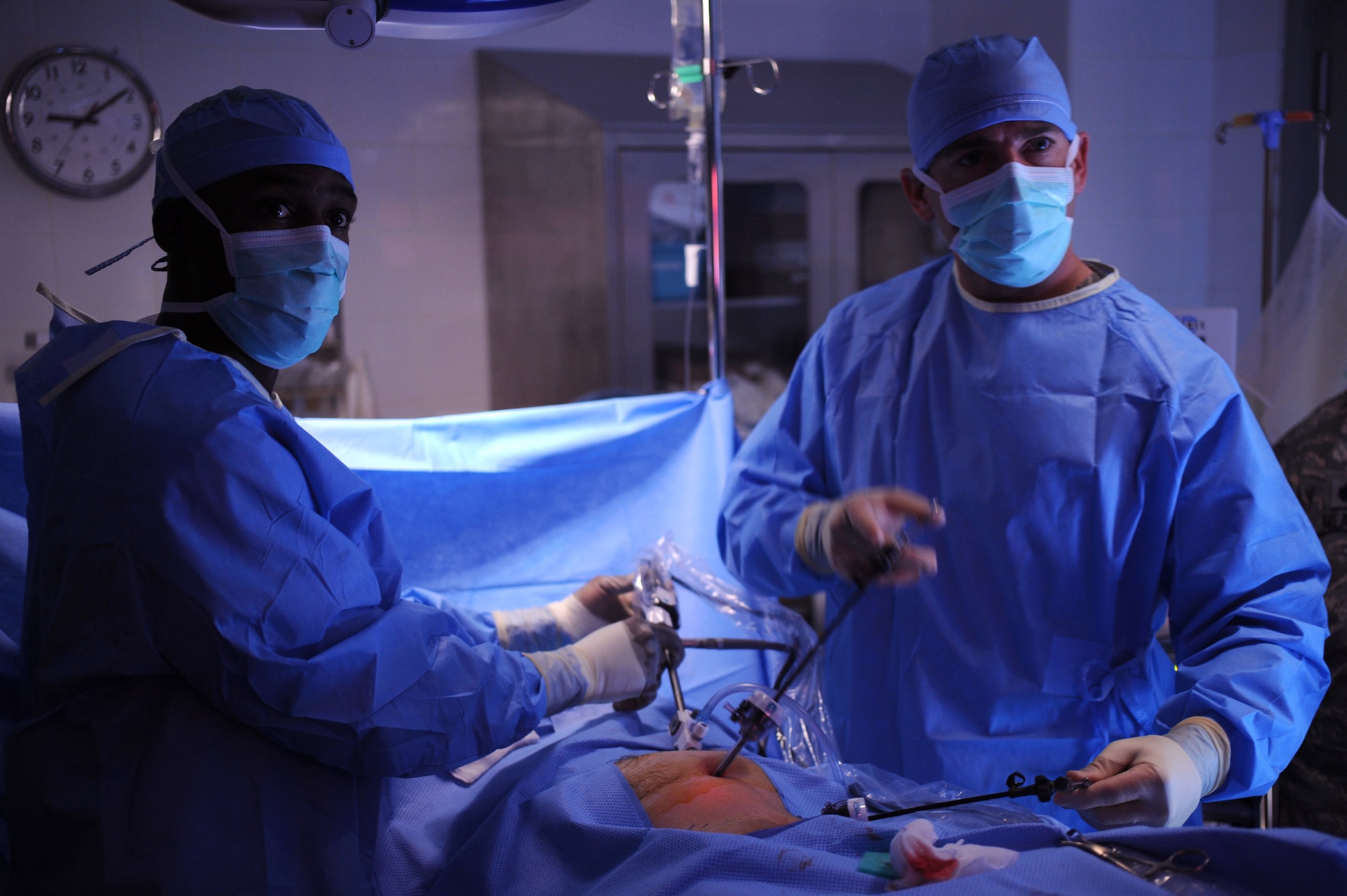 Staff Sgt. Troy Leach, 379th Expeditionary Medical Group surgical clinic and respiratory therapist, uses a laparoscopic fiber optic camera to aid Major (Doctor) Brian Holt, 379th Expeditionary Medical Group General Surgeon, in an operation for an inguinal hernia, June 5, 2009, at an undisclosed location in Southwest Asia.  This specific surgery allows the patient to return to duty quicker and with less pain.  The surgeries performed here range from elective to acute emergencies.  The surgical team provides treatment for patients coming in from all over the U.S. Central Command's Area of Responsibility.  Sergeant Leach hails from Nashville Tenn. and is deployed from Keesler Air Force Base, Miss.  Major Holt hails from St. Peters, Mo. and is deployed from Misawa Air Base, Japan.  Both are deployed in support of Operations Iraqi and Enduring Freedom and Combined Joint Task Force - Horn of Africa.  (U.S. Air Force photo/Senior Airman Andrew Satran/released)