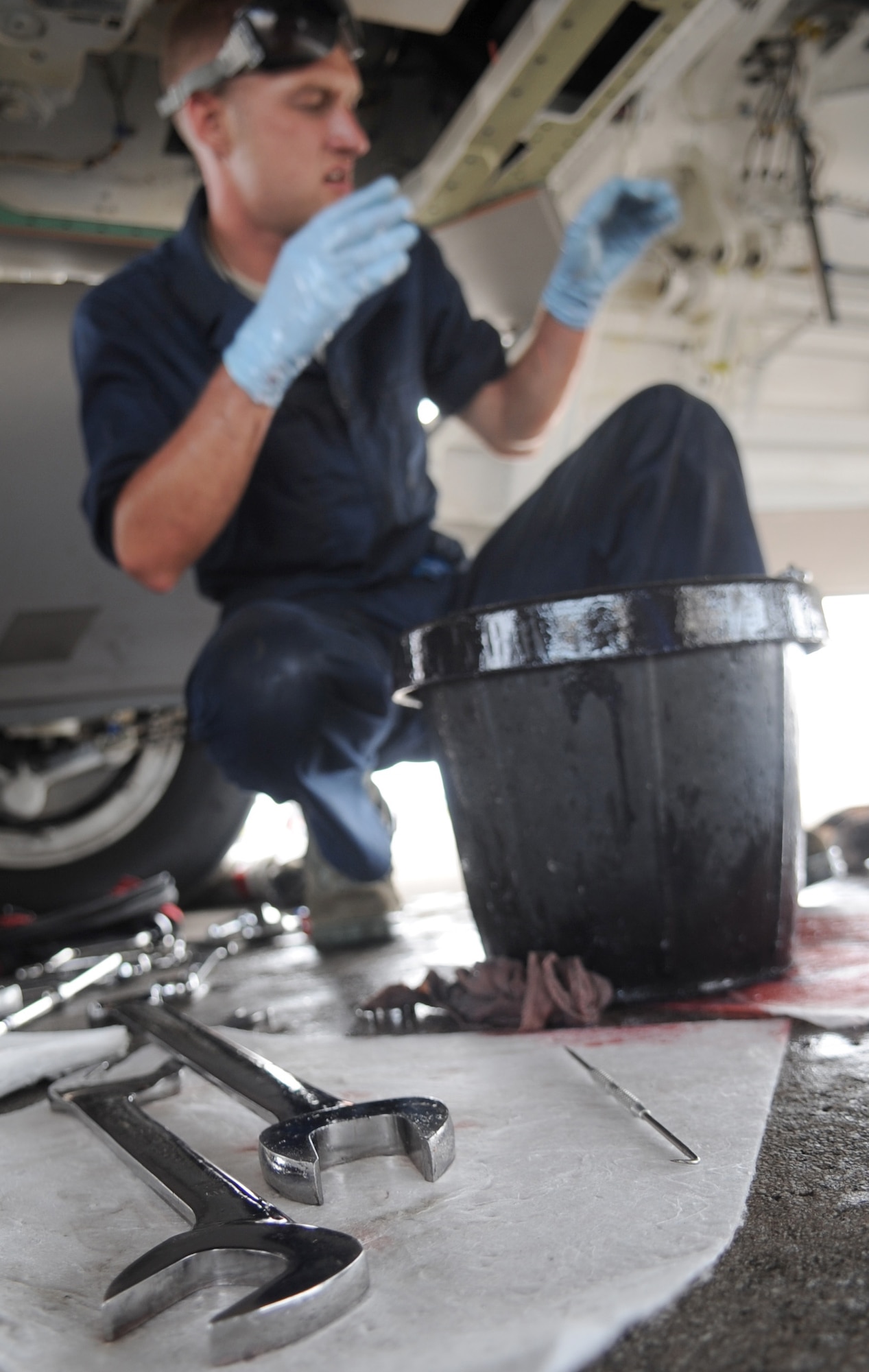 ANDERSEN AIR FORCE BASE, Guam - A crew chief’s tools lay at rest as Staff Sgt. Jeremiah Smith, 525th Expeditionary Aircraft Maintenance Unit F-22 Raptor crew chief, works on the hydraulic pump of an F-22 Raptor June 3.  (U.S. Air Force photo by Senior Airman Christopher Bush)
