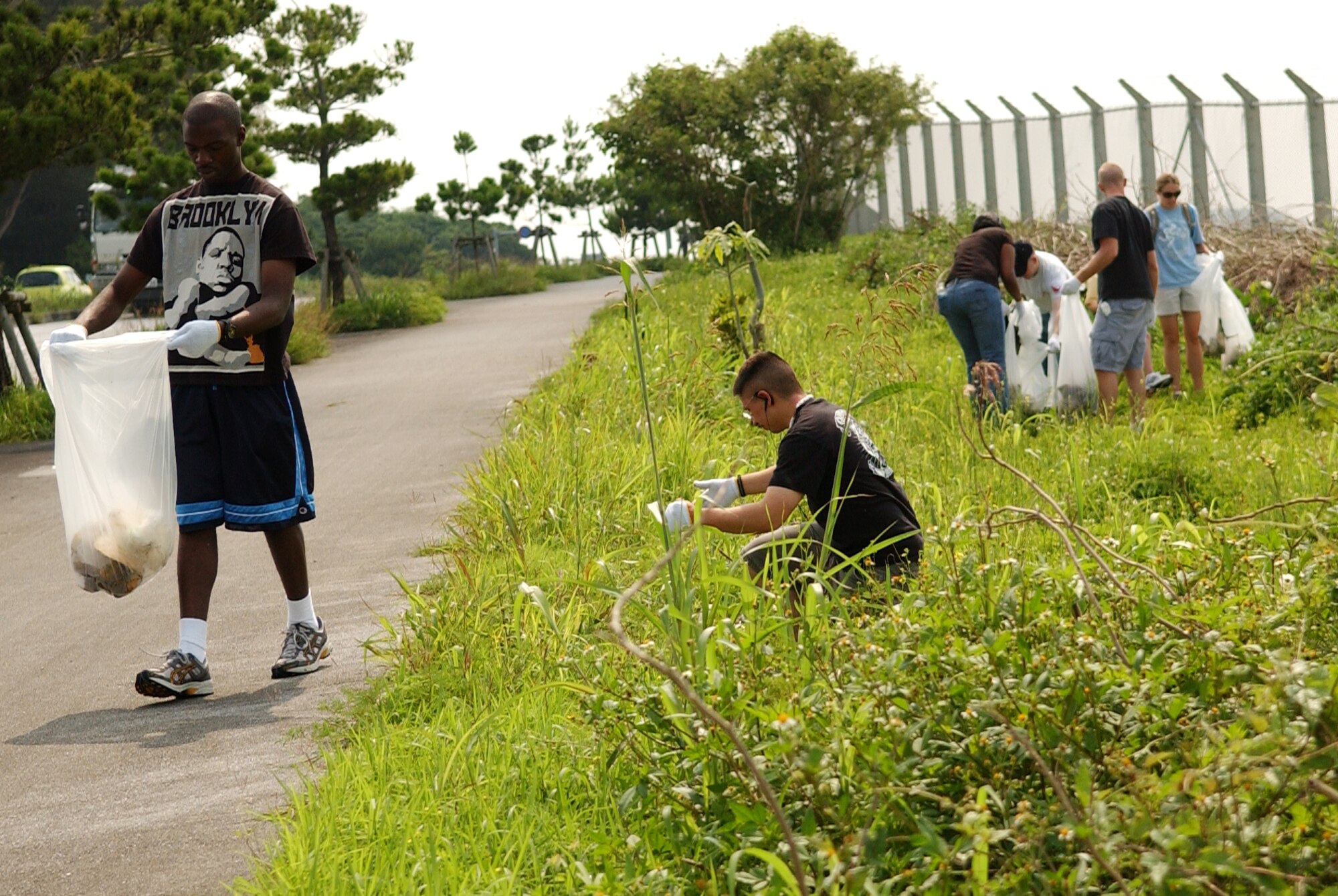 Kadena Airmen volunteer to pick up trash along the outside perimeter of Kadena Air Base between gate 3 and gate 1 June 6. Heroes of Planet Earth is a program inviting military personnel in an initiative to clean up, restore, and reclaim common outdoor venues used by guests of this host nation.  (U.S. Air Force photo/Tech. Sgt. Rey Ramon)   