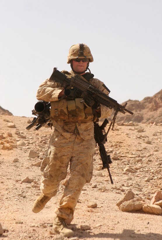 U.S. Marine Corps Lance Cpl. Matthew I. Sherman runs down a hill to join his fire team during a live-fire exercise in the Middle East, June 4, 2009. Sherman is assigned to the 1st Battalion, 1st Marine Regiment, 13th Marine Expeditionary Unit.