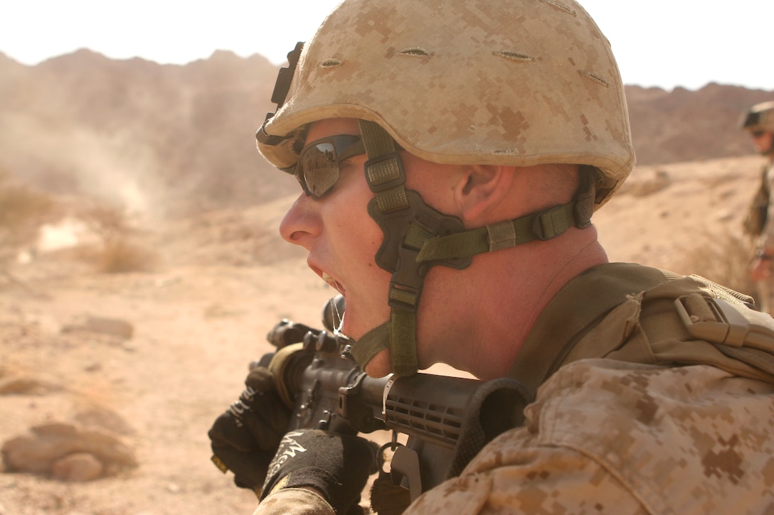 U.S. Marine Corps Lance Cpl. Kevin P. Herron shouts out commands to his fire team during a live-fire exercise in the Middle East, June 4, 2009. Herron a fire team leader is assigned to the 1st Battalion, 1st Marine Regiment, 13th Marine Expeditionary Unit.