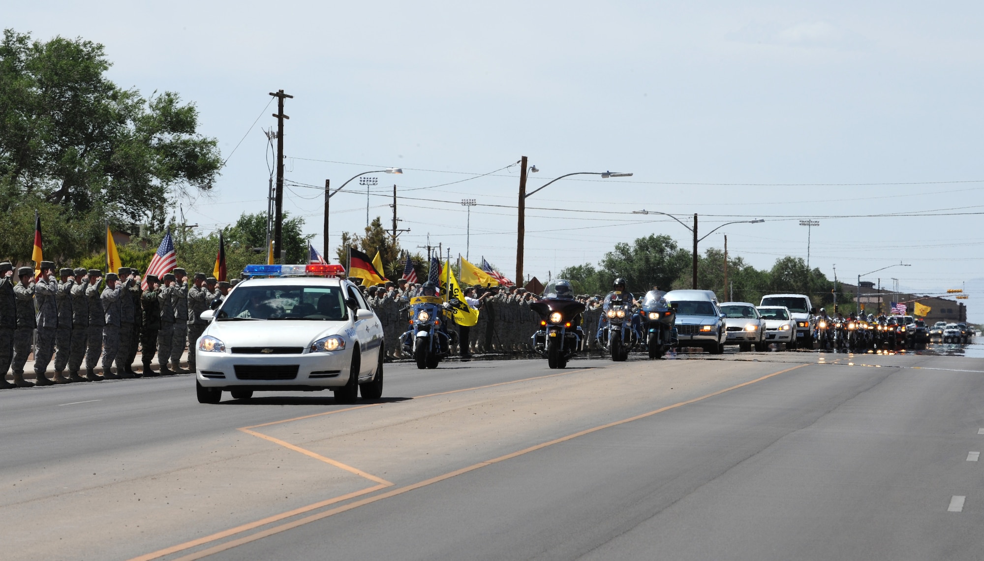 Members of Team Holloman render a final salute to a fallen Soldier, Army Specialist Christopher Kurth, June 11 at Holloman Air Force Base, N.M.,  The Soldier was killed in a grenade attack near Kirkuk, Iraq, June 4. Specialist Kurth was a native of Alamogordo, N.M., and was stationed at Fort Hood, Texas. (U.S. Air Force photo/Airman 1st Class Sondra Escutia)