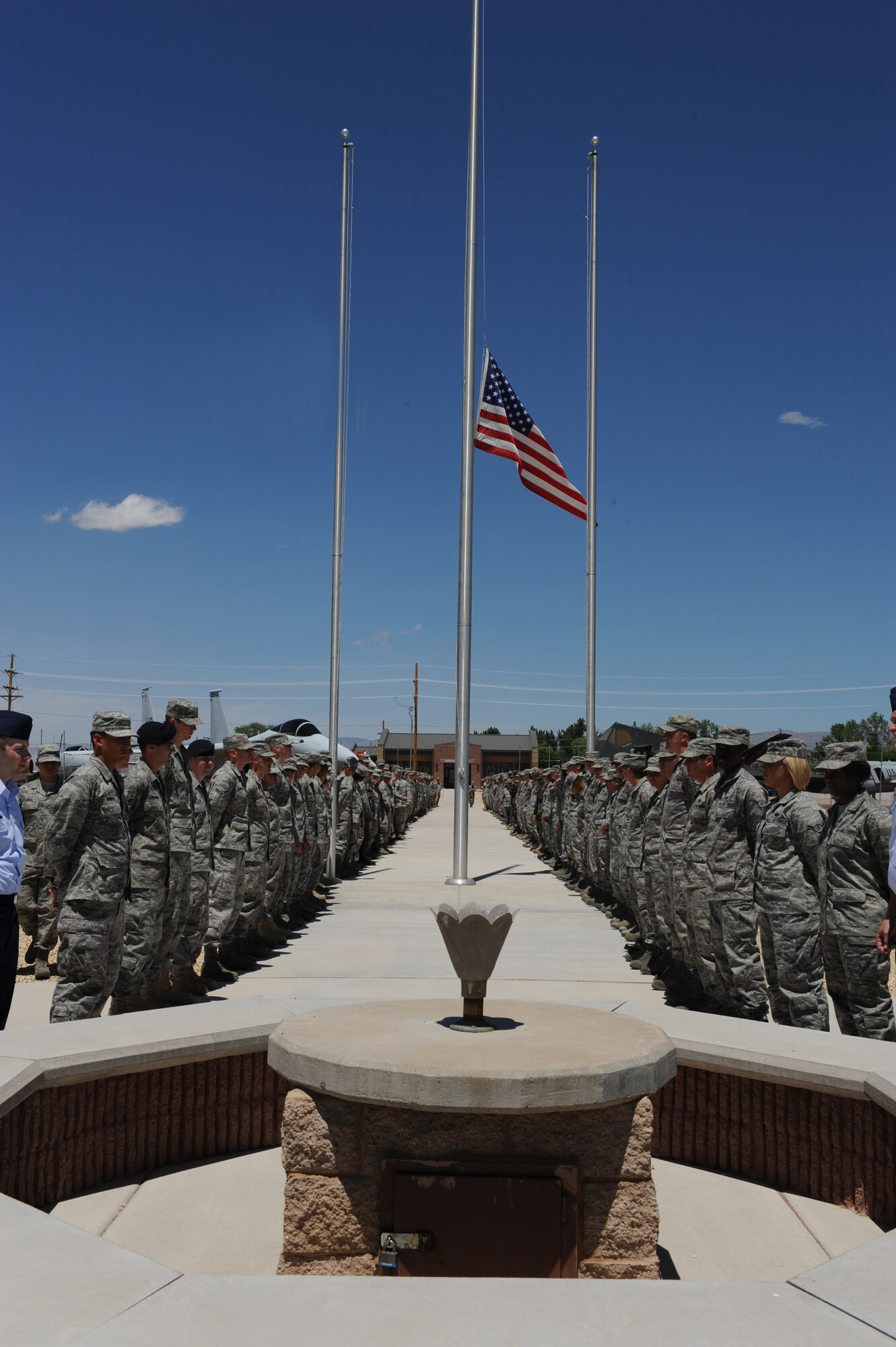 Members of Team Holloman stand before the POW/MIA monument June 11 at Holloman Air Force Base, N.M., before marching toward the front gate to render a final salute to Army Specialist Christopher Kurth. The Soldier was killed in a grenade attack near Kirkuk, Iraq, June 4. Specialist Kurth was a native of Alamogordo, N.M., and was stationed at Fort Hood, Texas. (U.S. Air Force photo/Airman 1st Class Sondra Escutia)