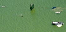 Parescuemen touchdown in the Caribbean Ocean June 9 while demonstrating a rigged alternate method zodiac, or RAMZ, capability jump for members of the Belize National Coast Guard and local media during Operation Southern Partner.  (U.S. Air Force photo/Staff Sgt. Bennie J. Davis III)