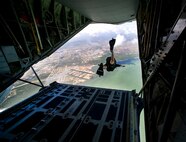 Pararescueman Staff Sgt. Blair Bearny jumps from the back of a C-130J Hercules June 9 to demonstrate a rigged alternate method zodiac, or RAMZ, capability jump into the Caribbean Ocean for members of the Belize National Coast Guard and local media during Operation Southern Partner. (U.S. Air Force photo/Staff Sgt. Bennie J. Davis III)