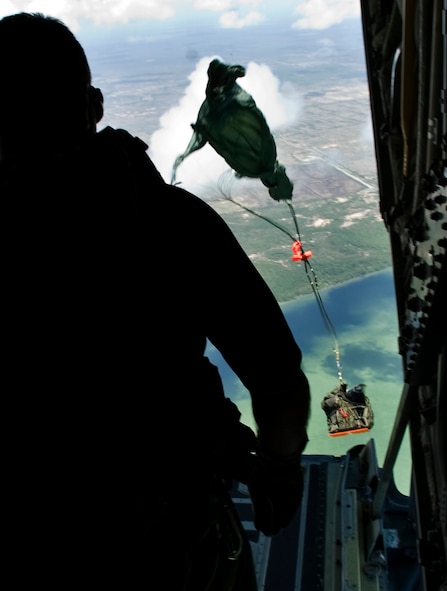 Pararescueman and jump master Senior Master Sgt. Michael Fleming watches as a rigged alternate method zodiac, or RAMZ, package leaves his C-130J Hercules June 9 as part of a demonstration for members of the Belize National Coast Guard and local media during Operation Southern Partner.  (U.S. Air Force photo/Staff Sgt. Bennie J. Davis III)