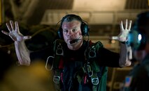 Pararescueman and jump master Senior Master Sgt. Michael Fleming signals a ten-minute warning to a team that will be demonstrating a rigged alternate method zodiac, or RAMZ, capability jump into the Caribbean Ocean June 9 for members of the Belize National Coast Guard and local media during Operation Southern Partner. (U.S. Air Force photo/Staff Sgt. Bennie J. Davis III)