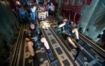 On board a C-130J Hercules, Capt. Travis Shepard, a combat rescue officer (left), and Senior Airman Brandon Smith, a pararescueman, prepare to demonstrate a rigged alternate method zodiac, or RAMZ, capability jump into the Caribbean Ocean June 9 for members of the Belize National Coast Guard and local media during Operation Southern Partner. (U.S. Air Force photo/Staff Sgt. Bennie J. Davis III)