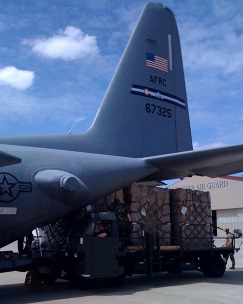 Members of the 185th Air Mobility Wing help load four crates of children's wheelchairs onto an Air Force Reserve C-130 June 11 in Sioux City, Iowa. The wheelchairs, transported by the 302nd Airlift Wing based at Peterson Air Force Base, Colo., are bound for Baghdad where they will be distributed to needy children. (U.S. Air Force photo/Capt. Brian McReynolds)