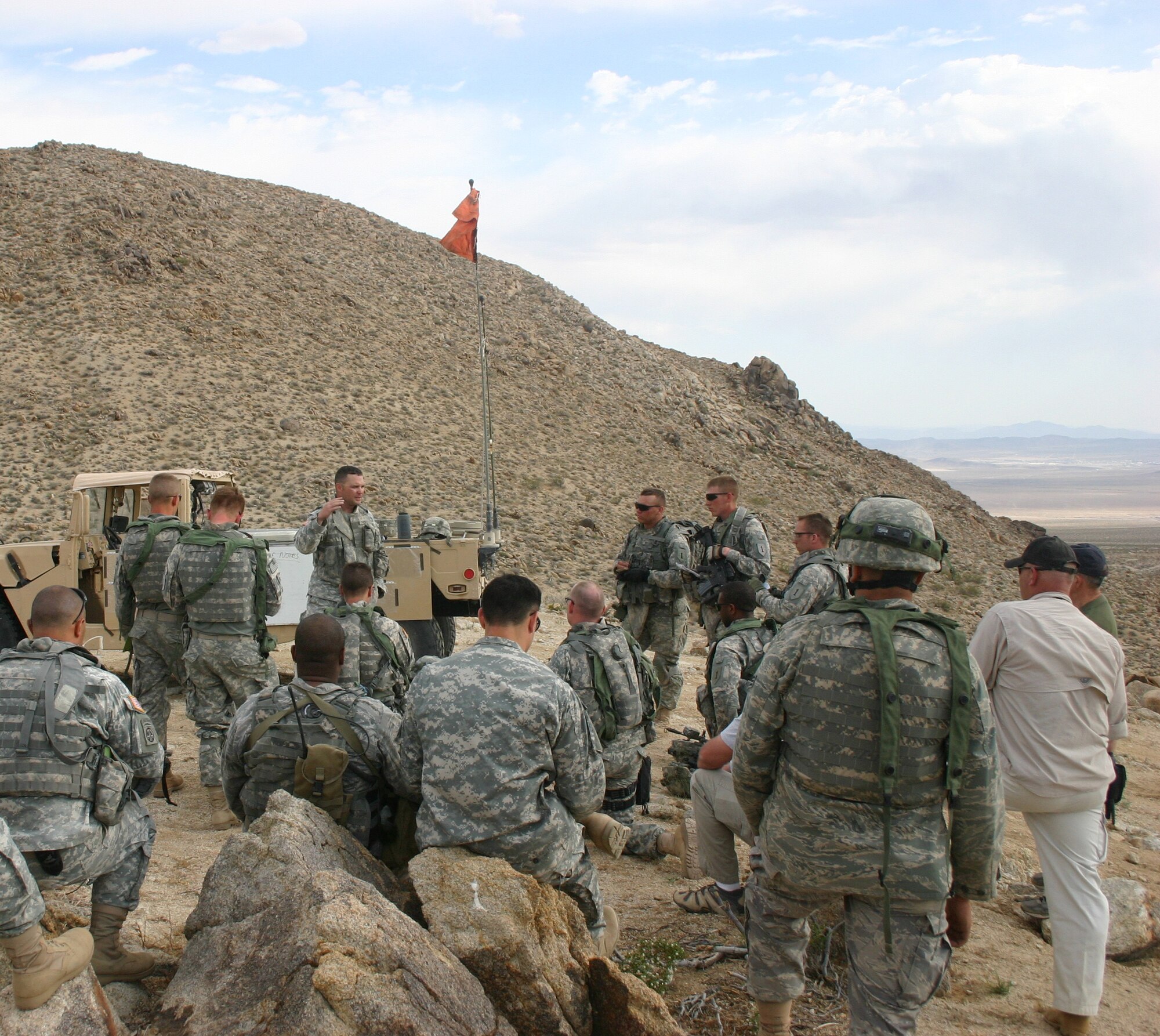 A training mentor at NTC conducts an after action review (AAR) with Army joint fires observers (JFOs) and Air Force joint terminal attack controllers (JTACs) after JAAT training at Ft. Irwin, Calif.  (Photo by Casey Bain, JFIIT, USJFCOM)