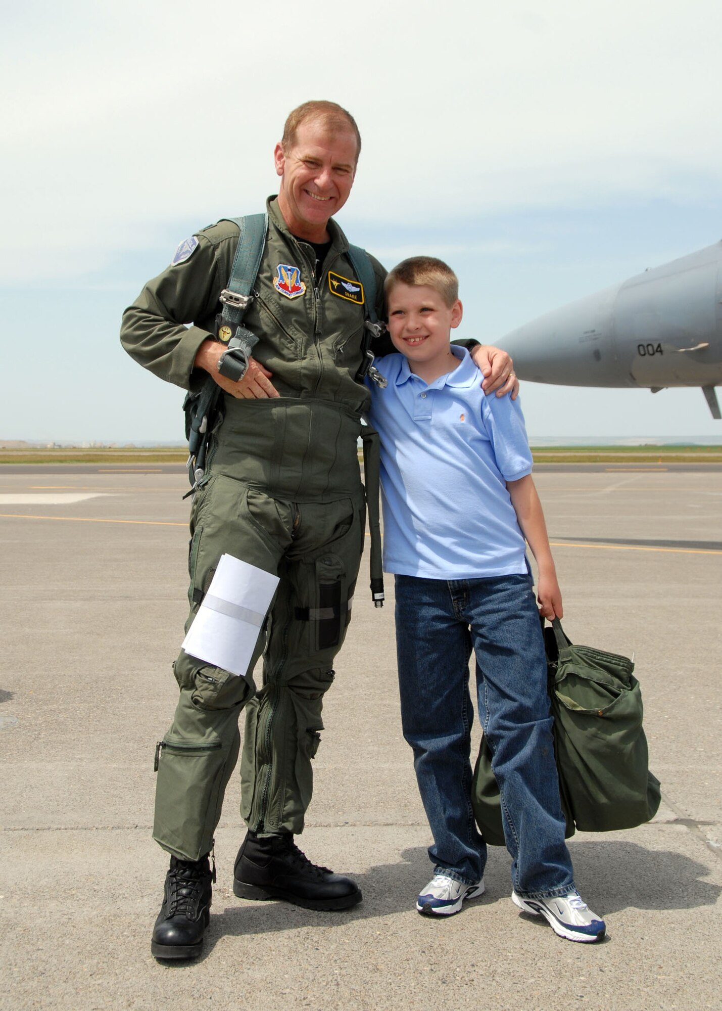 Lt. Col. Reed Drake gets a hug from his son Matthew, his biggest fan.  U.S. Air Force photo by Senior Master Sgt. Eric Peterson.
