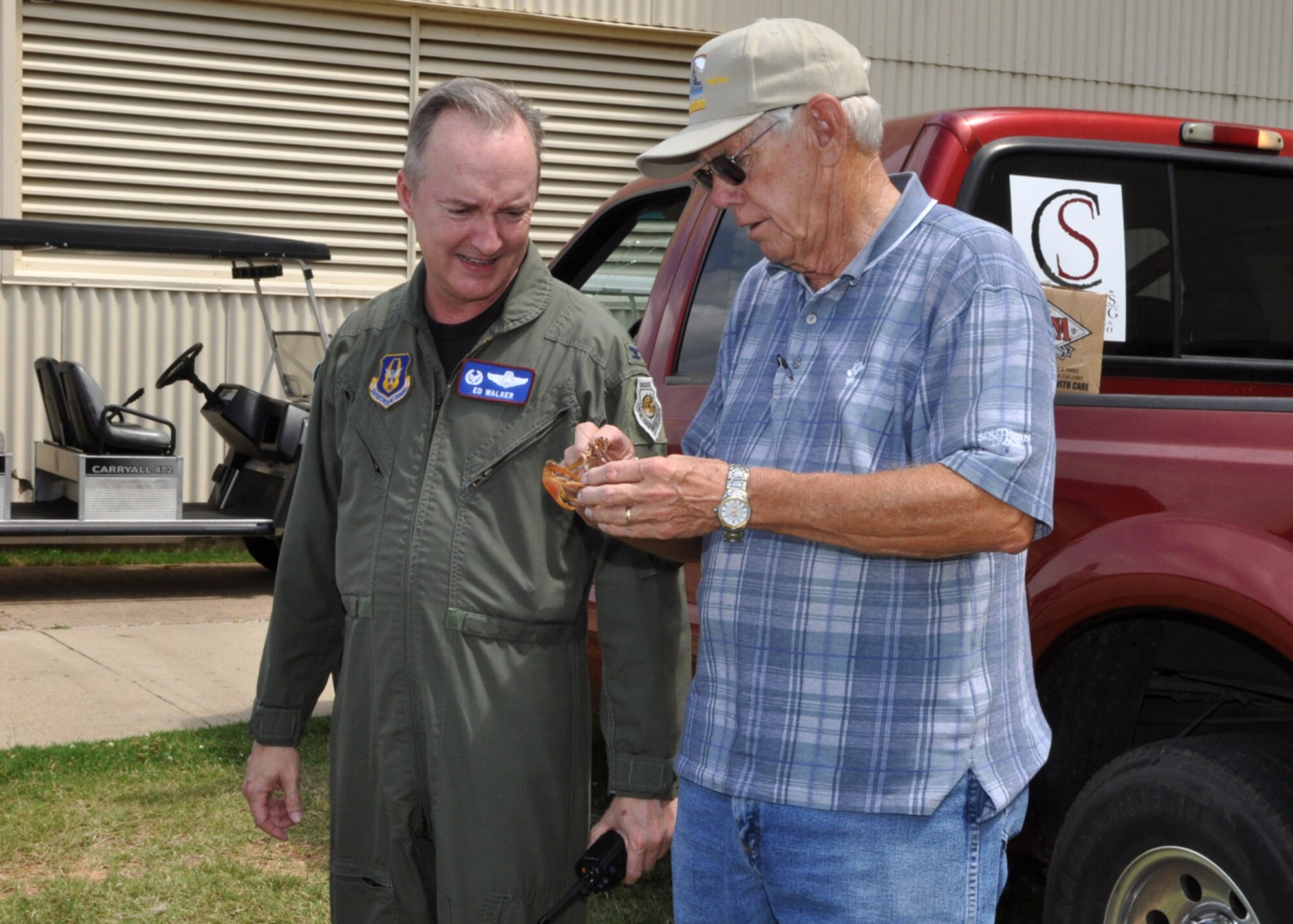 Colonel Ed Walker, 917th Wing, commander, receives a hands-on lesson in “crawdad” anatomy from Boyd parker, general manager, Shreveport Rubber and Gasket Company during a crawfish luncheon for 917th Wing Airmen at Barksdale Air Force Base, La., June 10, 2009. The luncheon was sponsored by Mr. Parker and the Shreveport Rubber and Gasket Company in “appreciation for what Barksdale Air Force Base does for the freedom we enjoy.” (U.S. Air Force photo/Tech. Sgt. Jeff Walston)