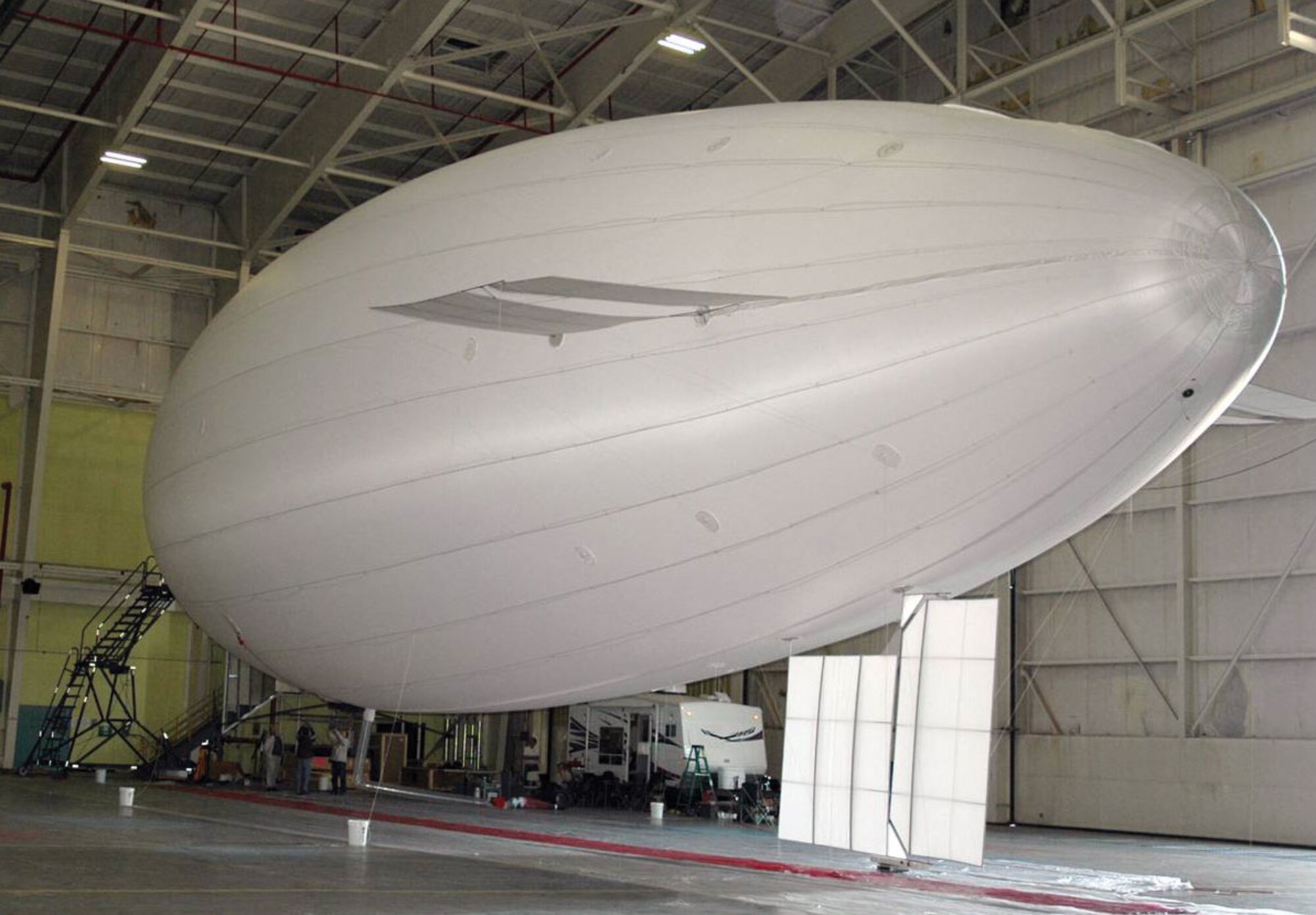 AFRL conducted successful integration test of a developmental high-altitude technology known as High Scout, a combined unmanned air vehicle (UAV)/airship configuration.  Depicted here is the helium-inflated High Scout airship prior to UAV mounting (AFRL image).