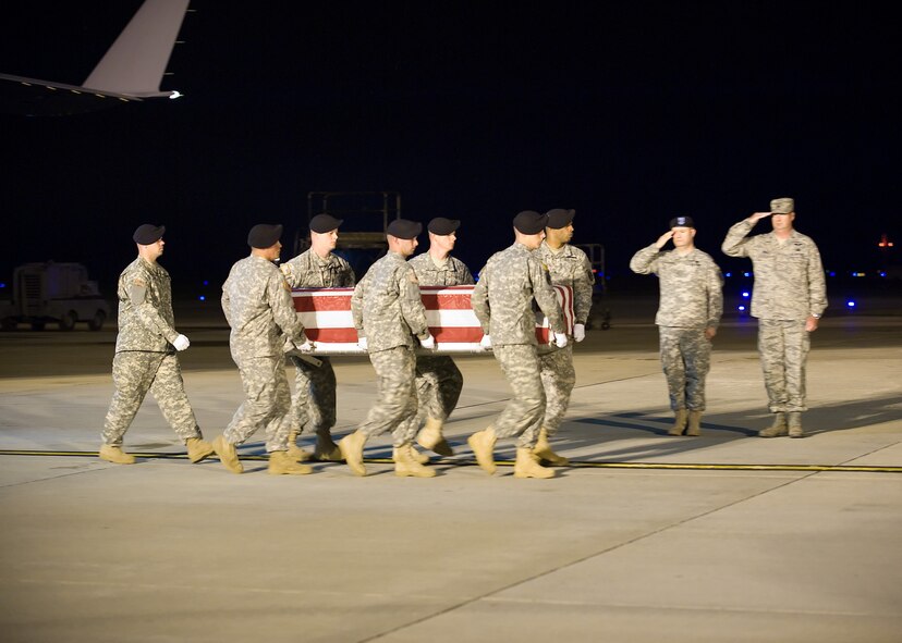 A U.S. Army carry team transfers the remains of Army Spc. Eduardo S. Silva, 25, of Greenfield, Calif., at Dover Air Force Base, Del., June 11. Specialist Silva was assigned to the 563rd Aviation Support Battalion, 159th Combat Aviation Brigade, 101st Airborne Division (Air Assault), Fort Campbell, Ky. (U.S. Air Force photo/Tom Randle)